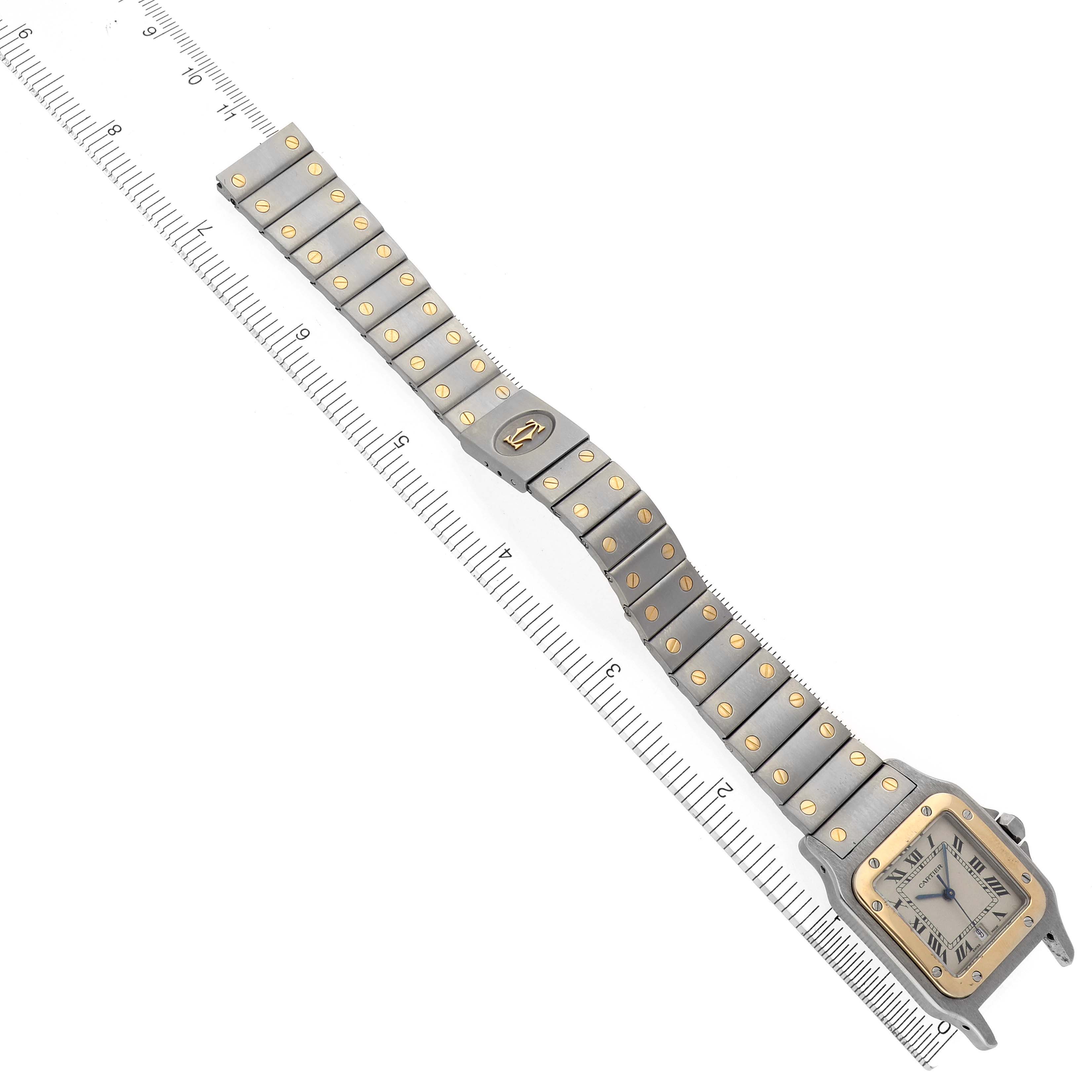The Cartier Santos W20011C4 Men's Steel and Gold (two tone) Silver Dial W20011C4 Men's Steel and Gold (two tone) Silver Dial watch is shown from the top, displaying the face, bezel, and full metal strap along a ruler.