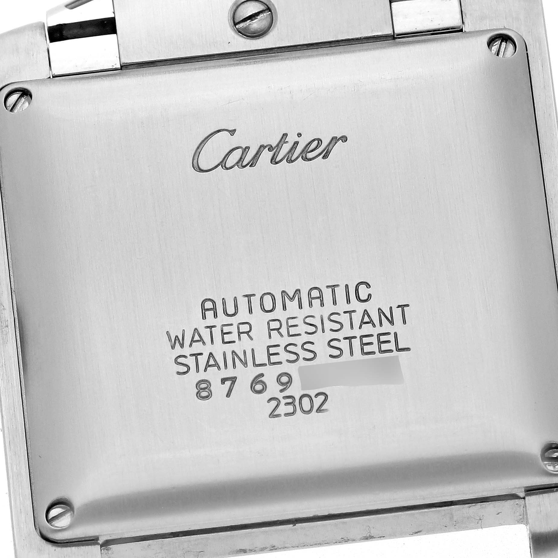 The image shows the back case of the Cartier Tank Française watch, displaying engravings and screws.