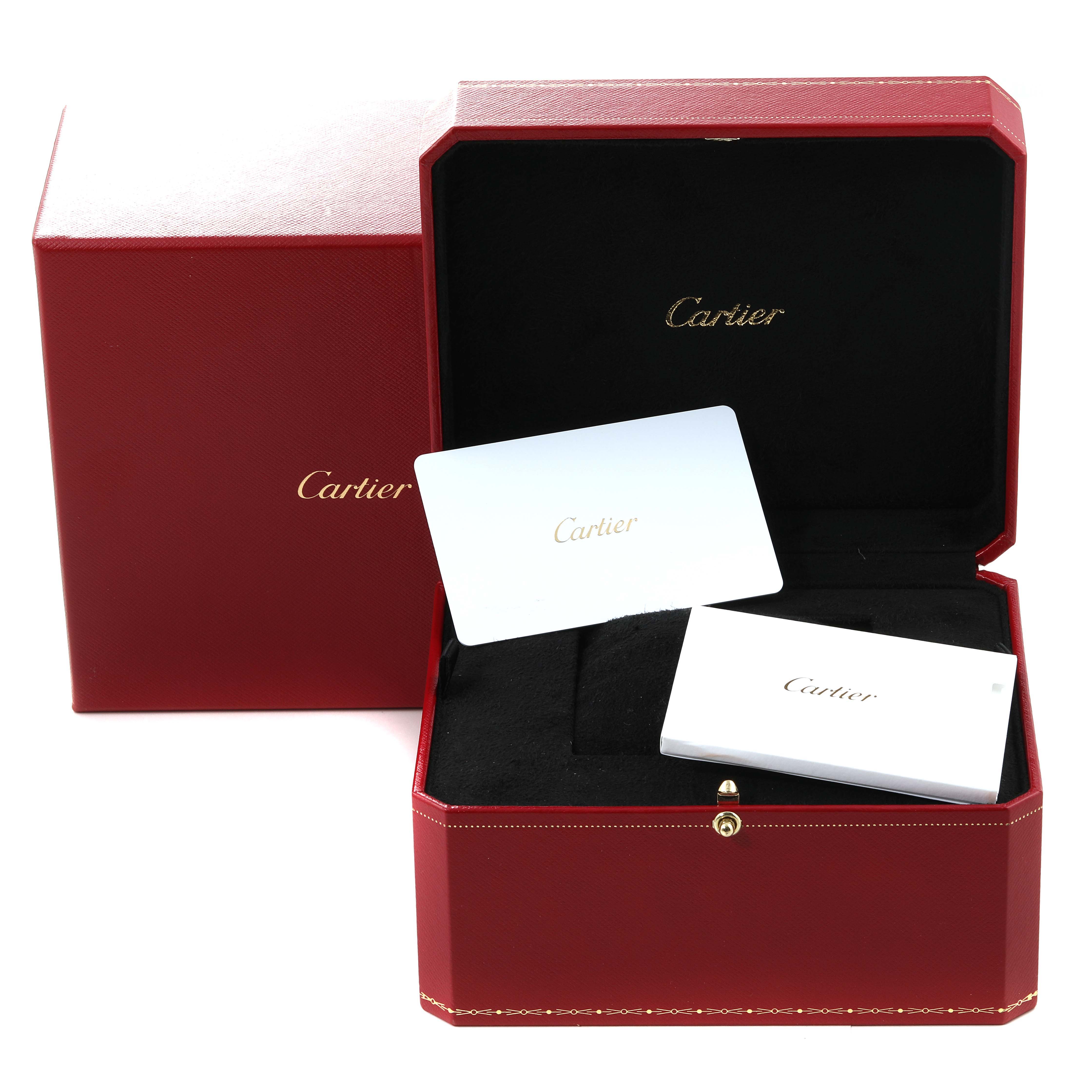 This image shows the red box and booklet for the Cartier Tank Must WSTA0052 Women's Stainless Steel Silver Dial WSTA0052 Women's Stainless Steel Silver Dial watch model, with the box open and tilted.