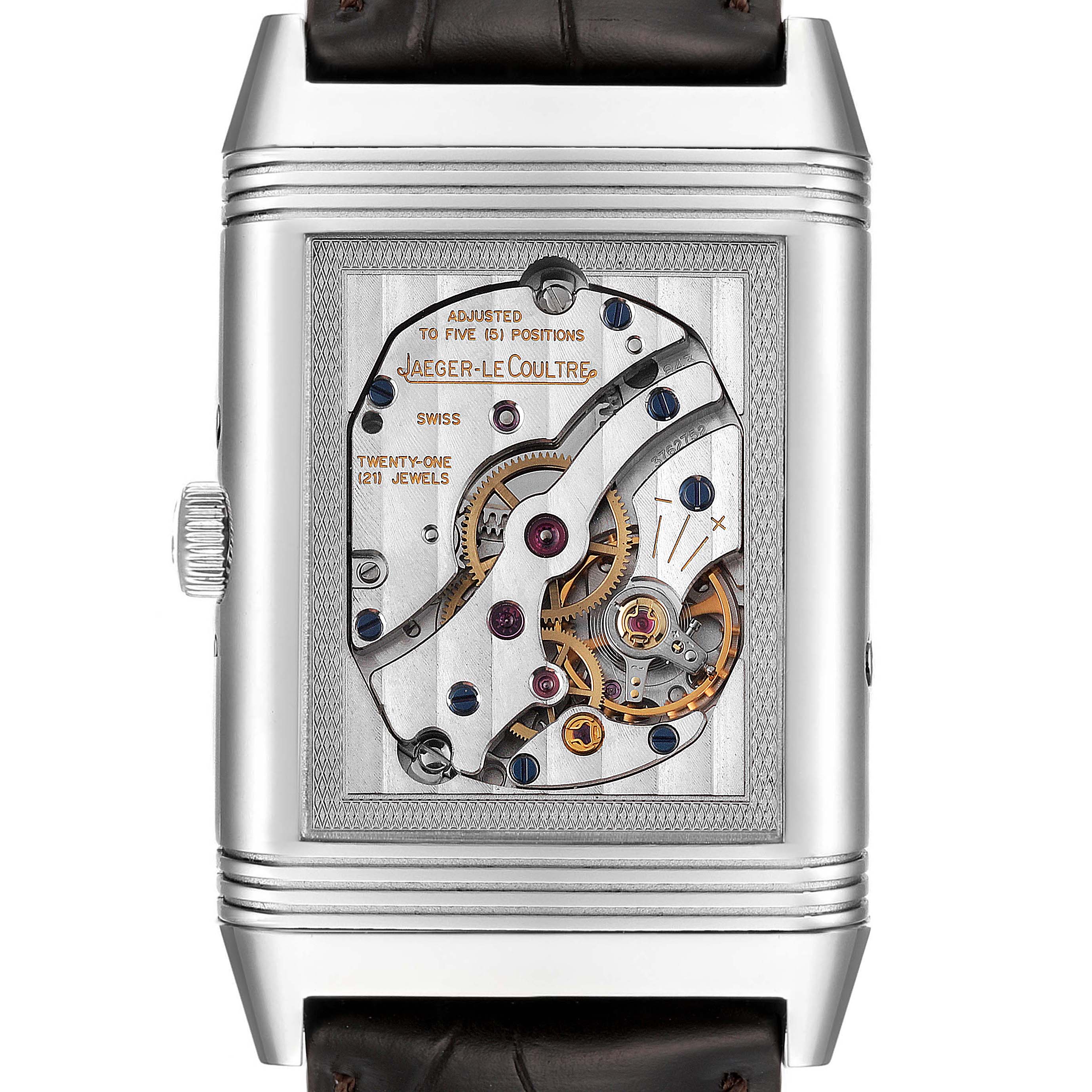 The image shows a close-up of the open mechanical back of a Jaeger-LeCoultre Reverso watch, highlighting its intricate inner components.