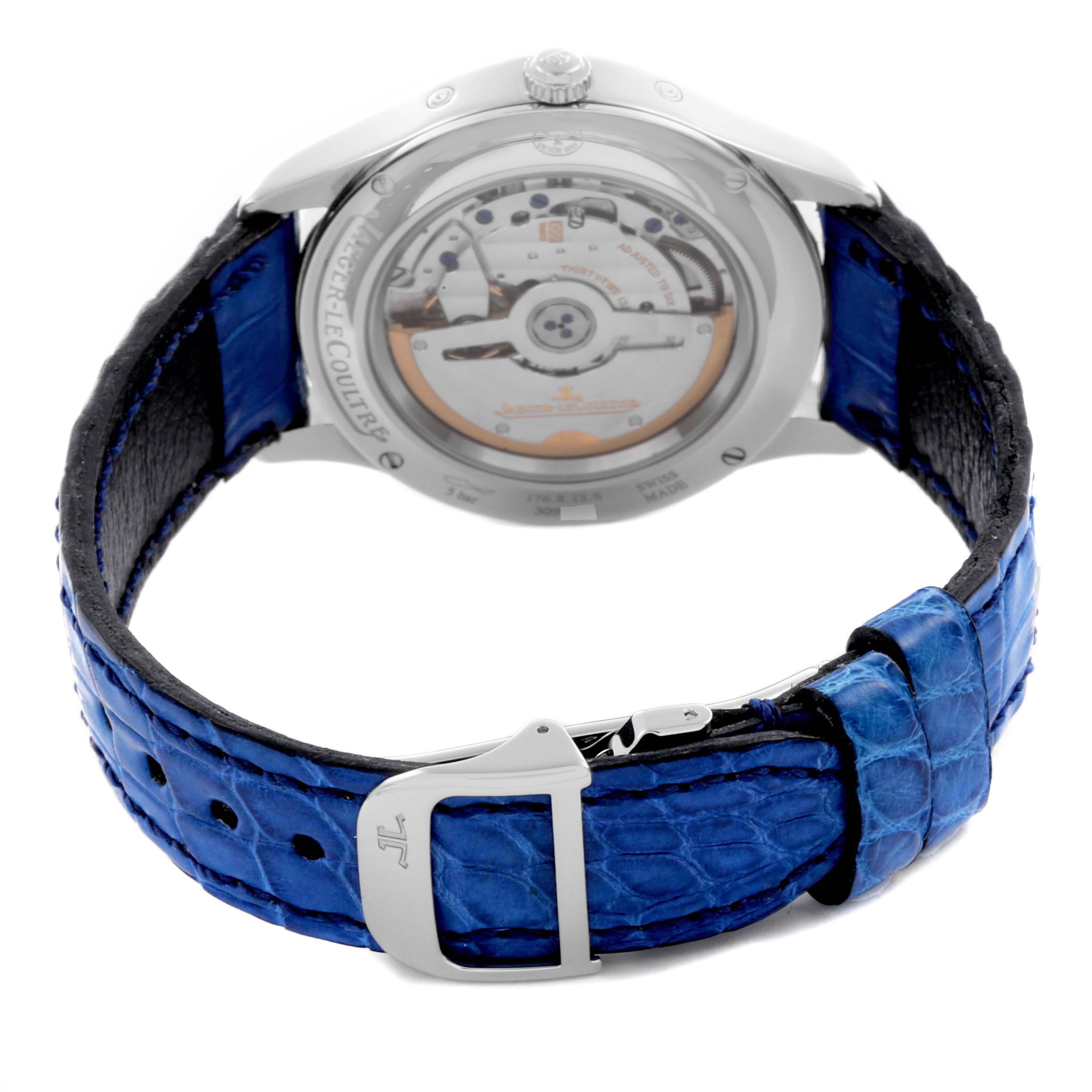 The Jaeger-LeCoultre Master watch is shown from the back, highlighting its movement and blue strap.