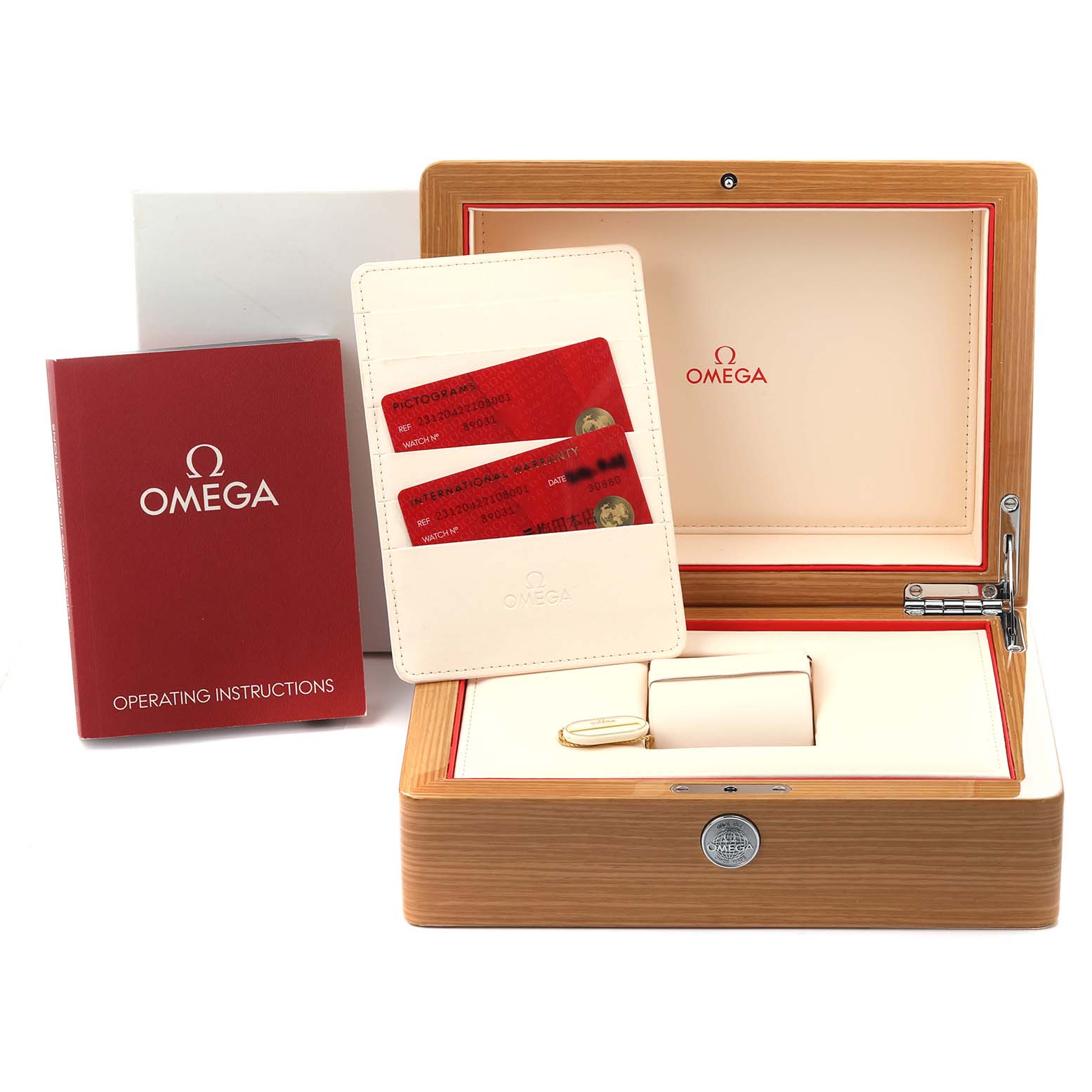 The image shows an Omega Seamaster box, operating instructions, and red cards in a wallet.