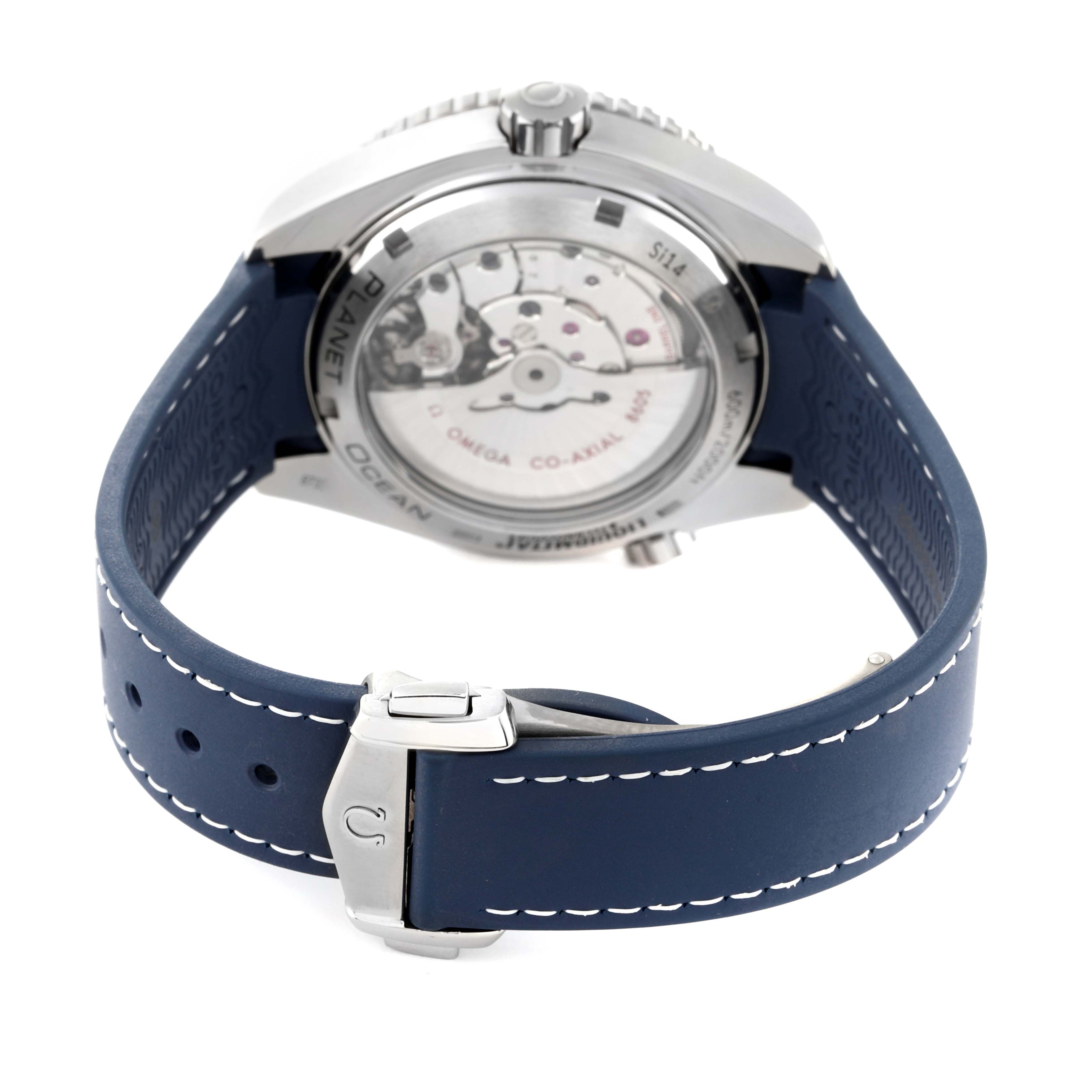 The image shows the back and side view of an Omega Planet Ocean 232.92.44.22.03.001 Men
s Titanium Blue Dial 232.92.44.22.03.001 Men
s Titanium Blue Dial model watch with a visible movement and blue strap.