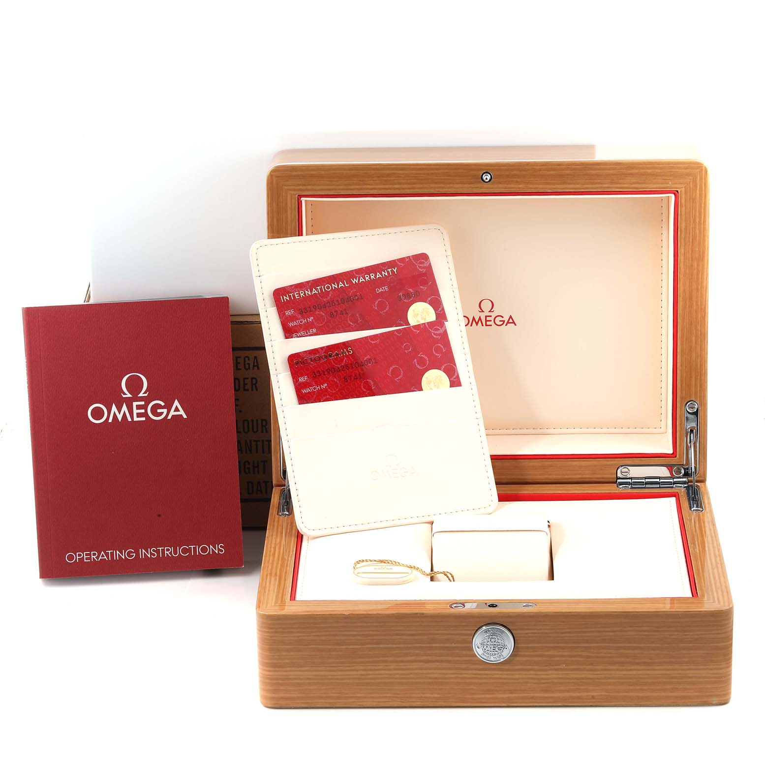 The image shows an open Omega Speedmaster 331.90.42.51.04.001 Men's Stainless Steel White Dial 331.90.42.51.04.001 Men's Stainless Steel White Dial watch box with the operating instructions, warranty cards, and original packaging accessories.