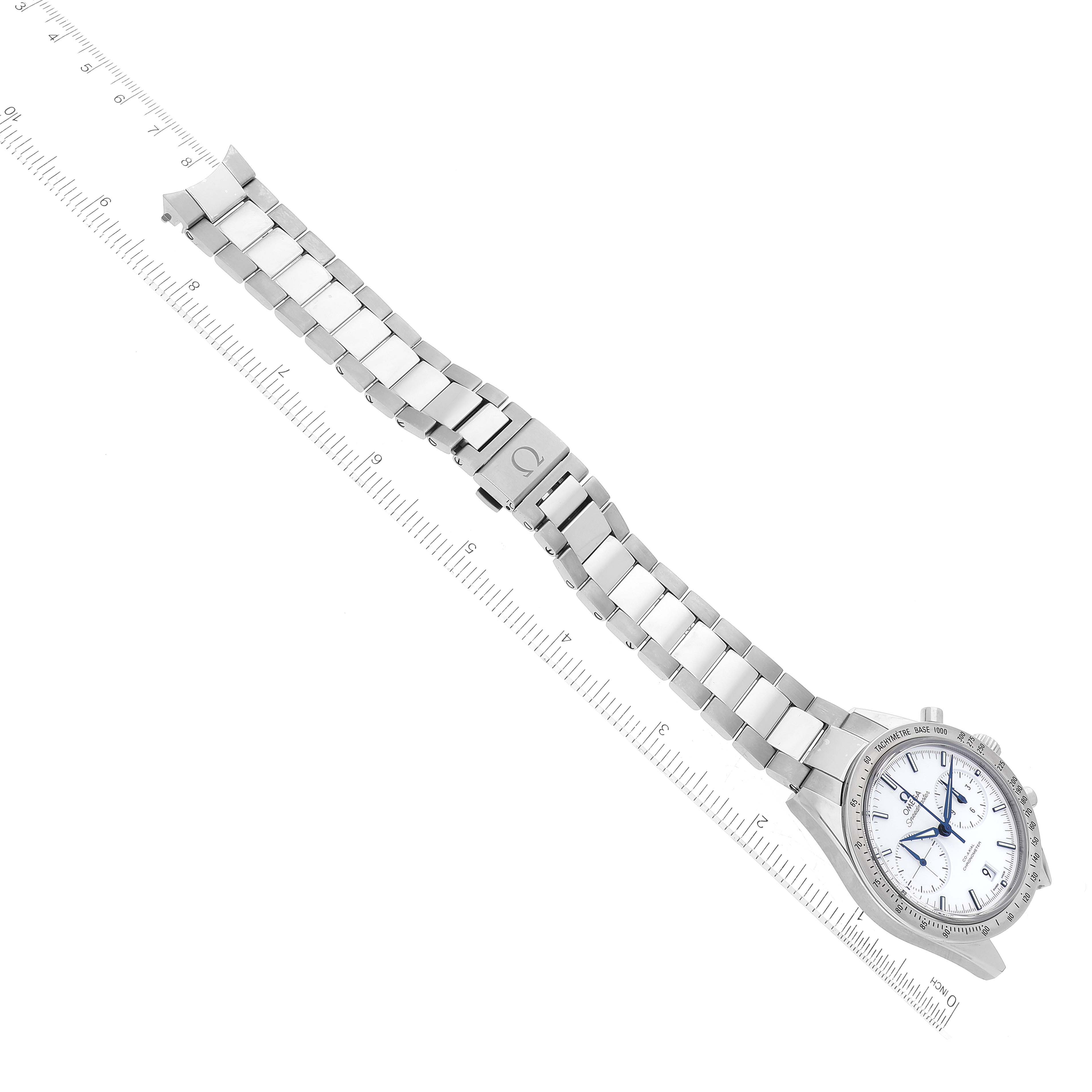 The image shows a top-down view of an Omega Speedmaster 331.90.42.51.04.001 Men's Stainless Steel White Dial 331.90.42.51.04.001 Men's Stainless Steel White Dial watch with its metal bracelet and a ruler for scale.
