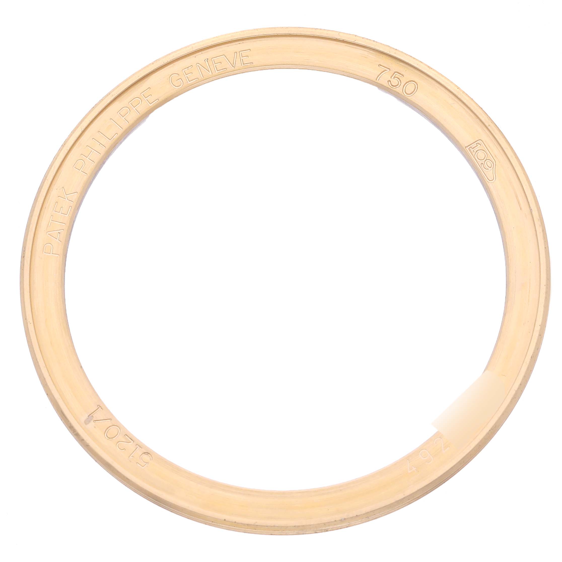 The image shows a close-up of the gold bezel for a Patek Philippe Calatrava 5120/1J Men's Yellow Gold Silver Dial 5120/1J Men's Yellow Gold Silver Dial watch, engraved with text and numbers.