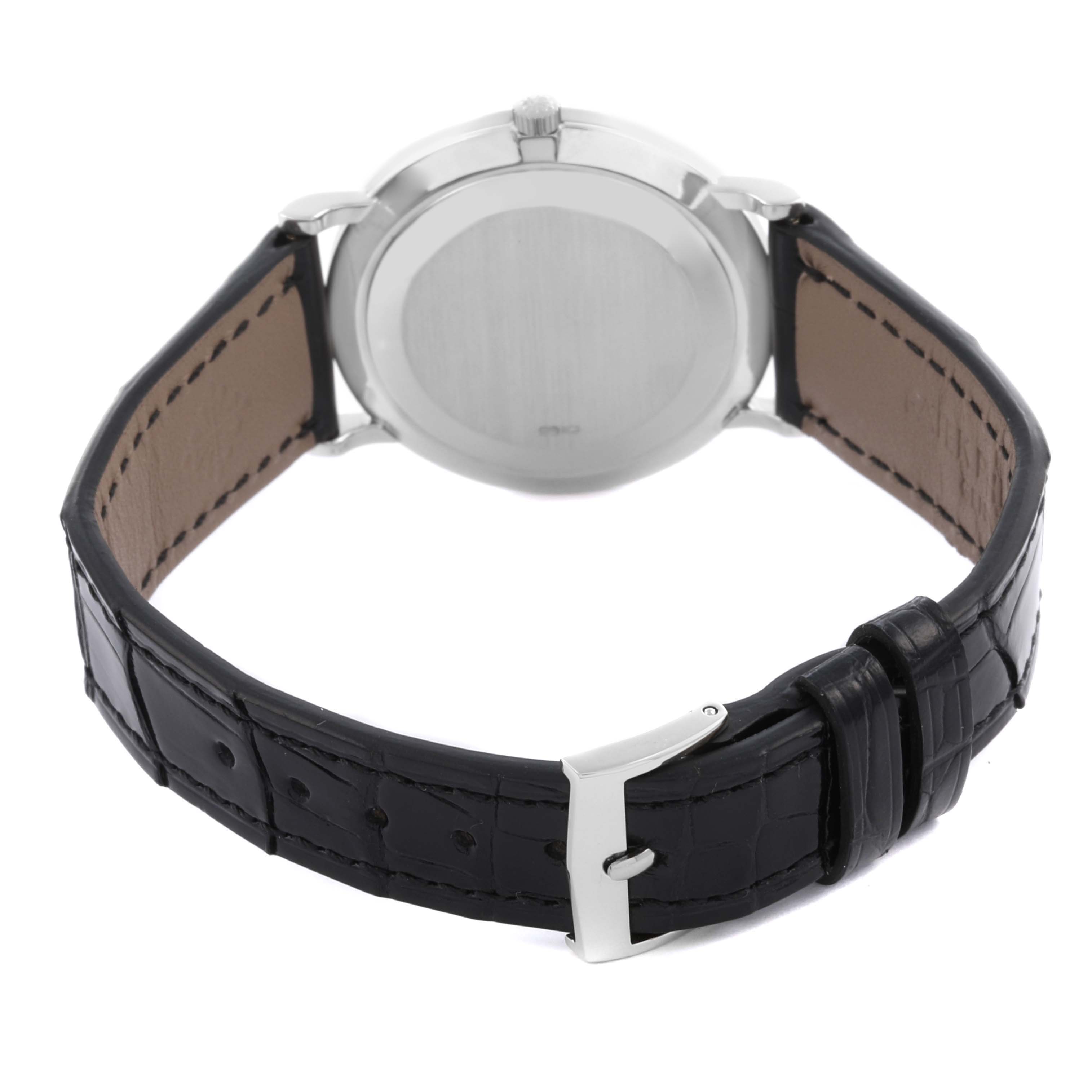 The image shows the back view of a Patek Philippe Calatrava 3919G-001 Men
s White Gold White Dial 3919G-001 Men
s White Gold White Dial watch with a black leather strap and a silver buckle.