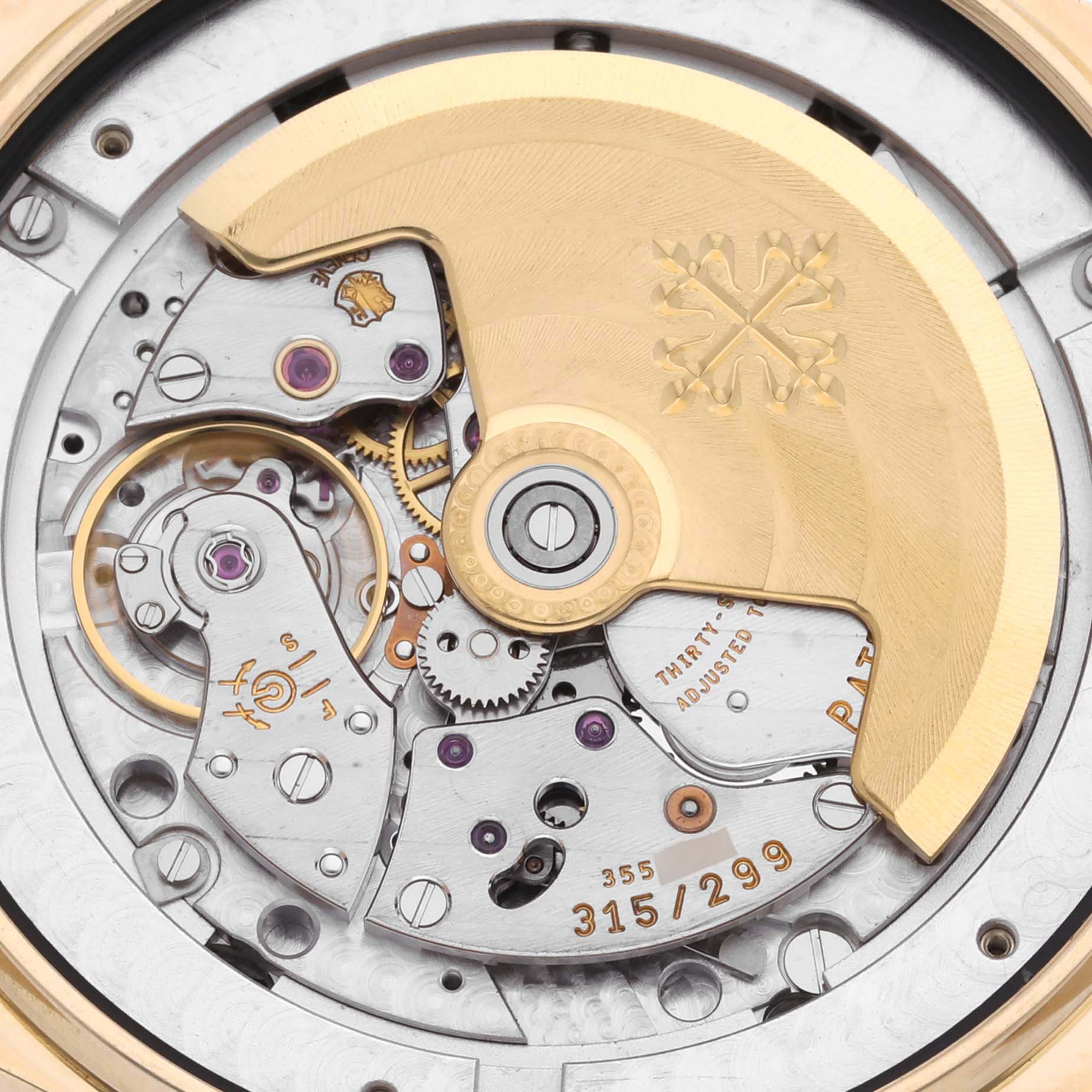 The image shows the intricate movement of the Patek Philippe Complications 5146J-010 Men's Yellow Gold Grey Dial 5146J-010 Men's Yellow Gold Grey Dial watch from a top-down angle.