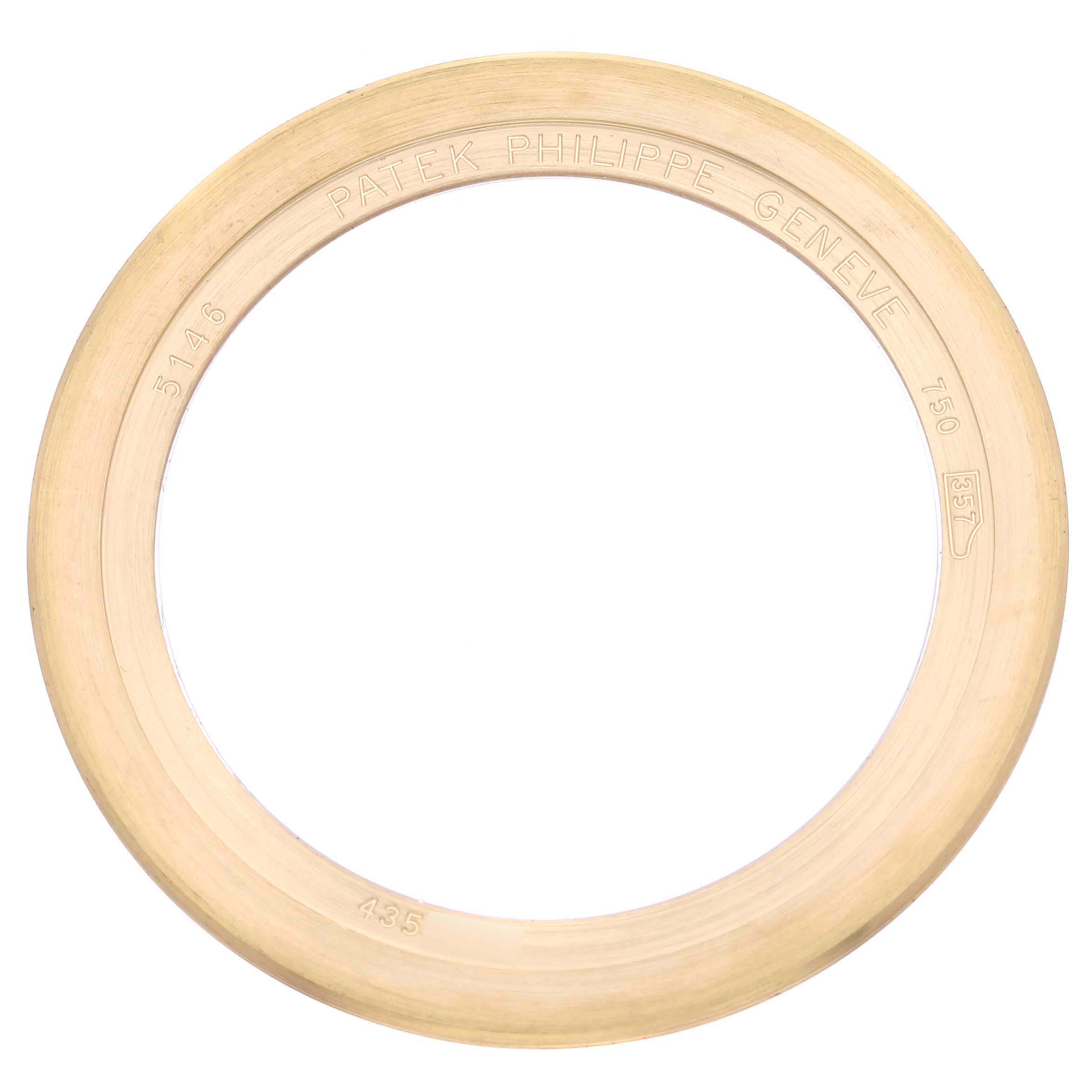 The image shows a gold bezel from the Patek Philippe Complications 5146J-010 Men's Yellow Gold Grey Dial 5146J-010 Men's Yellow Gold Grey Dial model, viewed from above with engraved details visible.