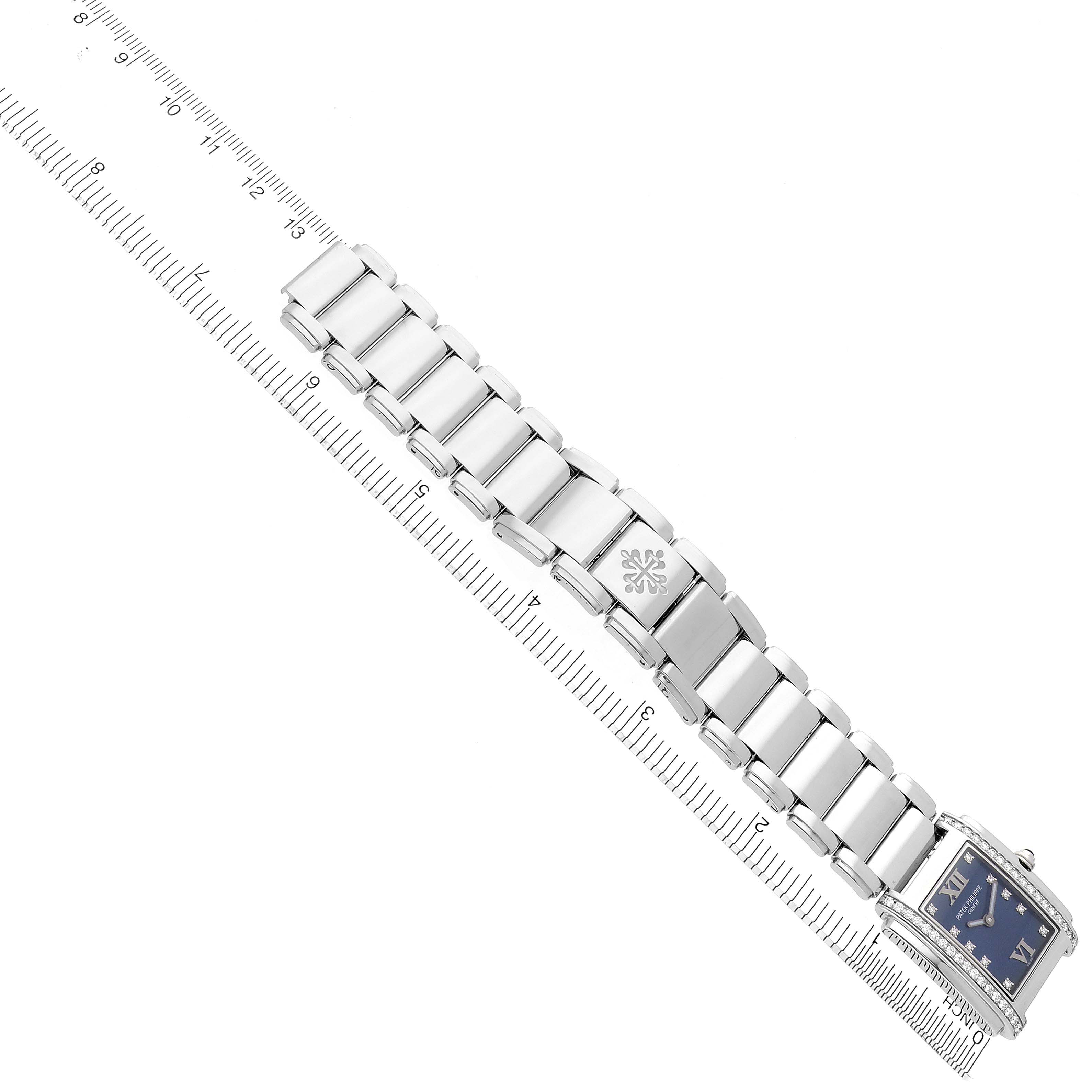 The image shows the Patek Philippe Twenty-4 4910/10A-012 Women's Stainless Steel Blue Dial 4910/10A-012 Women's Stainless Steel Blue Dial watch at a top-down angle, focusing on the bracelet and face.