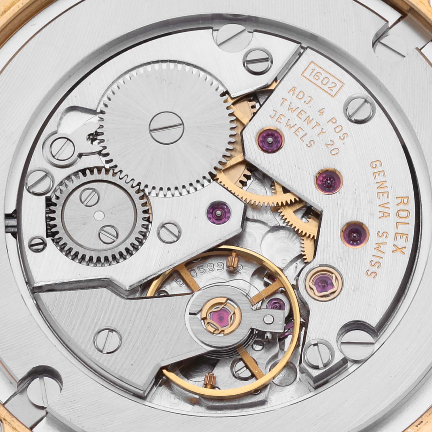 The image shows a close-up of the Rolex Cellini 5115 Men's Yellow Gold White Dial 5115 Men's Yellow Gold White Dial movement, focusing on gears and jewels.