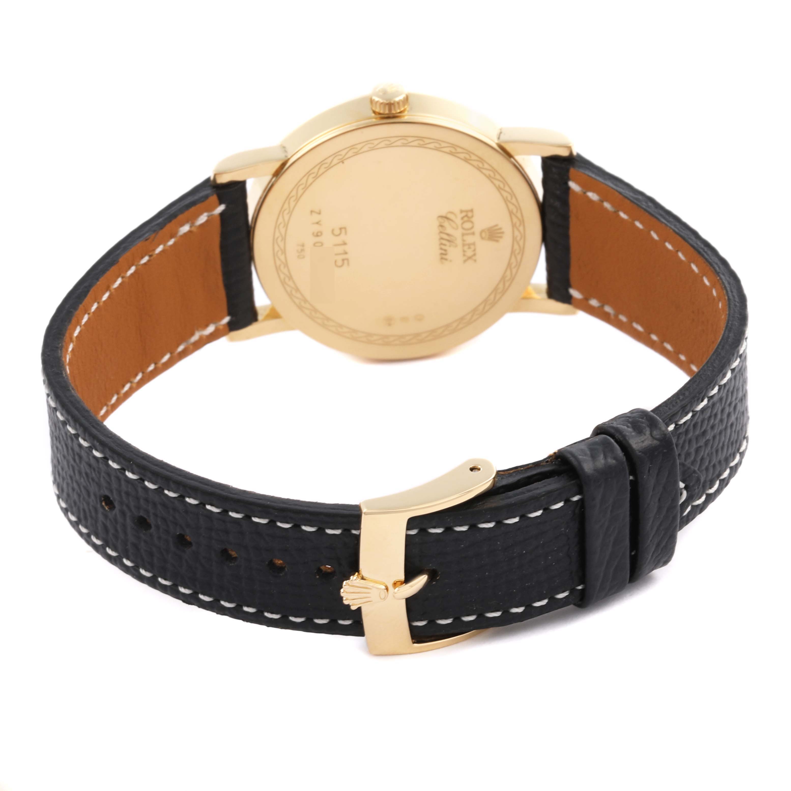 The Rolex Cellini 5115 Men's Yellow Gold White Dial 5115 Men's Yellow Gold White Dial watch is shown from the back, highlighting its gold case, crown, and black leather strap with a gold buckle.