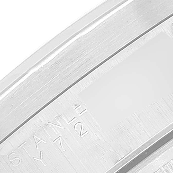 This image shows a close-up of the clasp from a Rolex Date 15210 Men
s Stainless Steel Black Dial 15210 Men
s Stainless Steel Black Dial model watch, highlighting the engraving on the stainless steel surface.