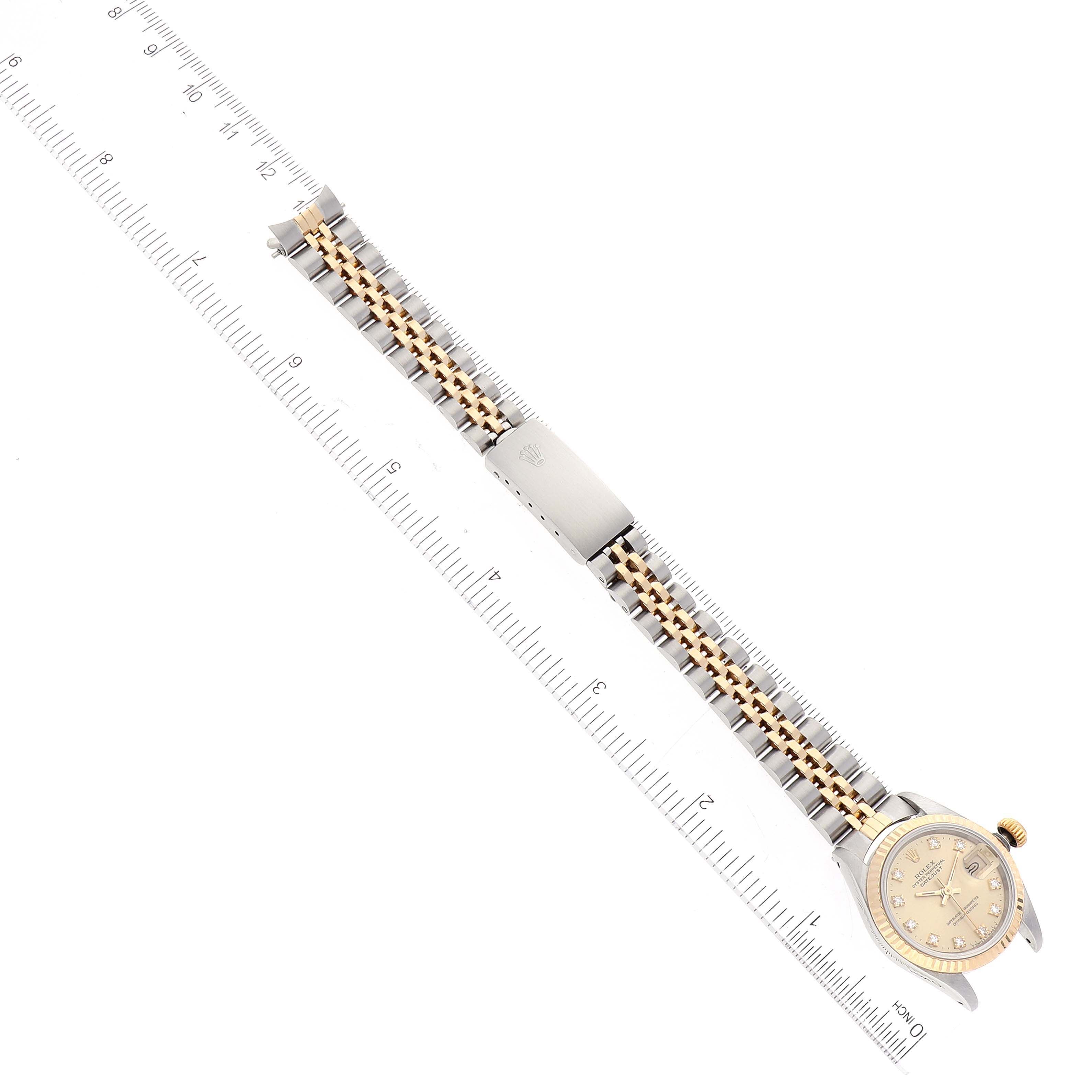 The Rolex Datejust 69173 Women's Steel and Gold (two tone) Champagne Dial 69173 Women's Steel and Gold (two tone) Champagne Dial watch is shown from a top-down angle, displaying the full length of the band with a ruler for scale.