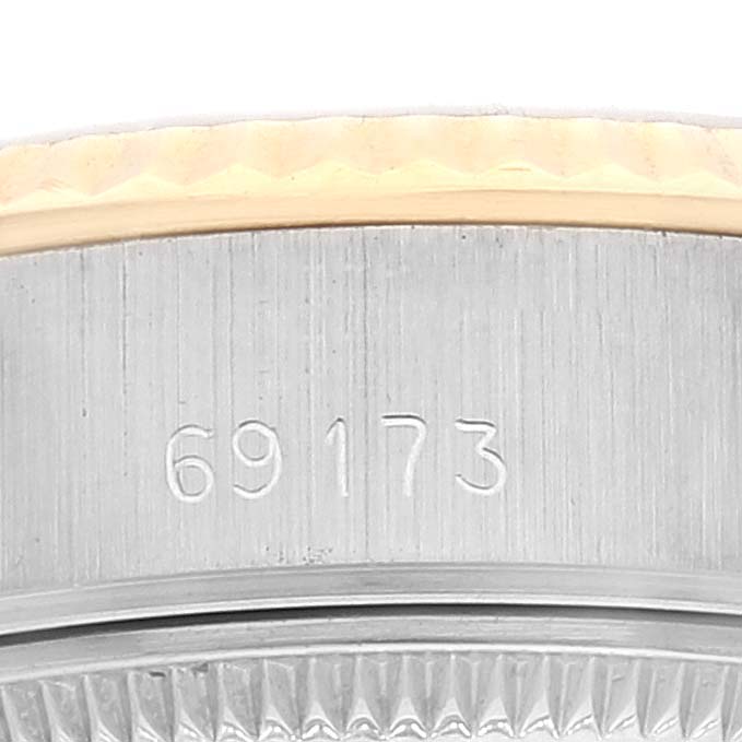 This image shows a close-up of the case side and fluted bezel of a Rolex Datejust 69173 Women's Steel and Gold (two tone) Champagne Dial 69173 Women's Steel and Gold (two tone) Champagne Dial model 69173.