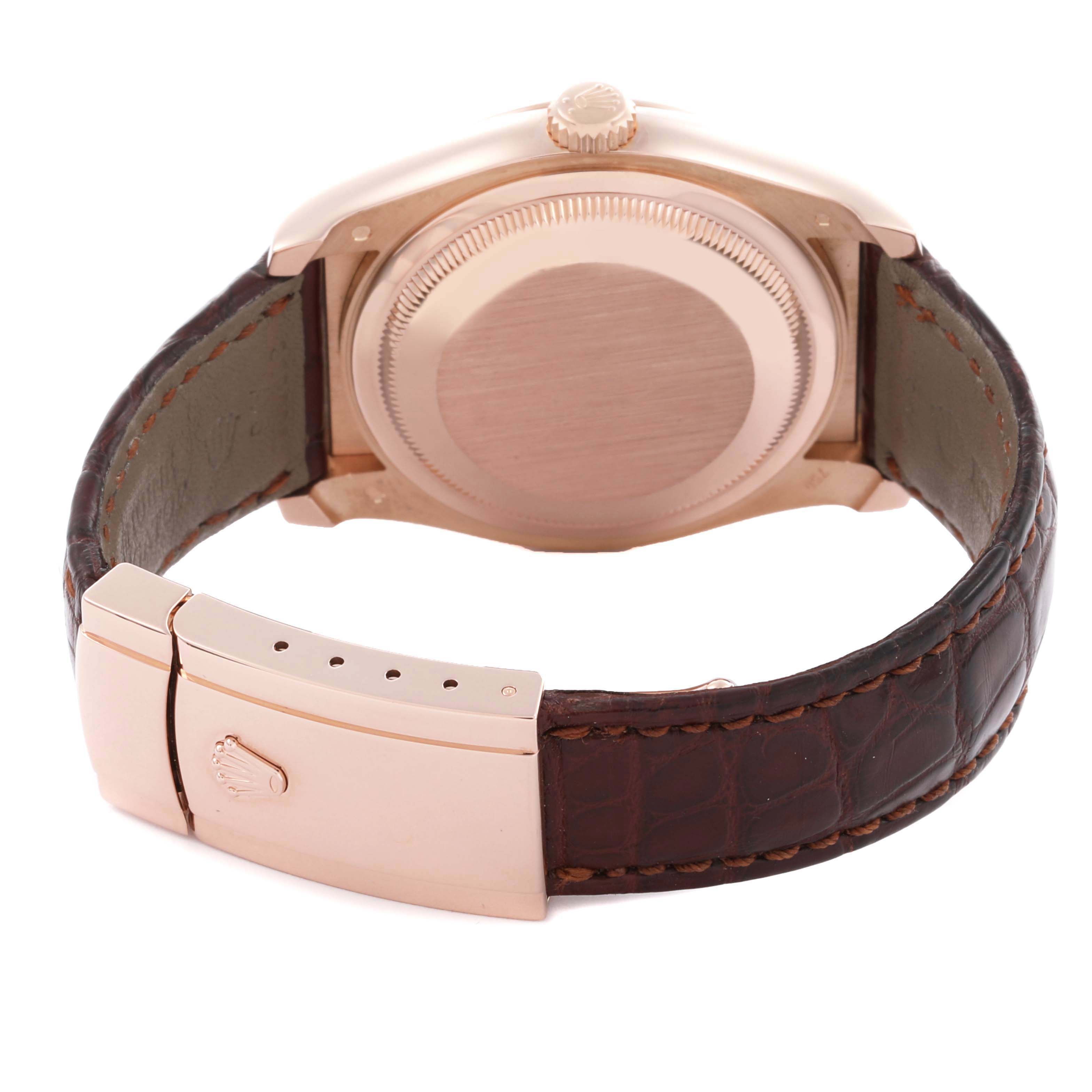 The image shows the back of a Rolex Datejust 116135 Men's Rose Gold Pink Dial 116135 Men's Rose Gold Pink Dial watch, highlighting the case back, crown, and brown leather strap with clasp.