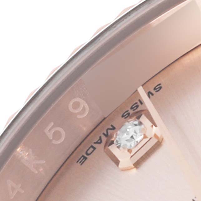 The image shows a close-up of a Rolex Datejust 116135 Men's Rose Gold Pink Dial 116135 Men's Rose Gold Pink Dial watch dial, highlighting the diamond marker and part of the chapter ring.