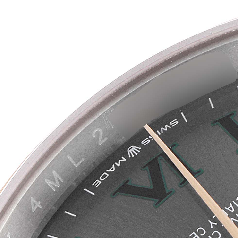 This close-up image shows a portion of the dial and the "Swiss Made" marking of a Rolex Datejust 126201 Men
s Steel and Gold (two tone) Grey Dial 126201 Men
s Steel and Gold (two tone) Grey Dial watch.