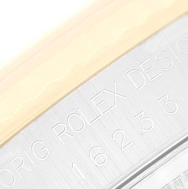 This close-up image shows the engraved case edge of a Rolex Datejust 16233 Men's Steel and Gold (two tone) Champagne Dial 16233 Men's Steel and Gold (two tone) Champagne Dial watch.