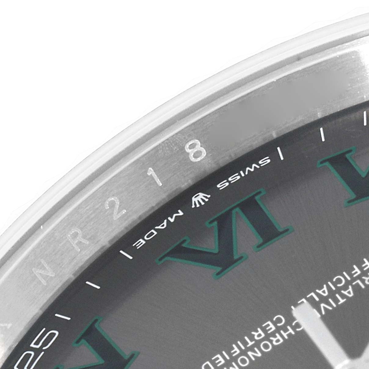This close-up image shows the upper left section of the Rolex Datejust 41 126334 Men
s Stainless Steel Grey Dial 126334 Men
s Stainless Steel Grey Dial dial, with the Roman numeral markers and a part of the bezel.