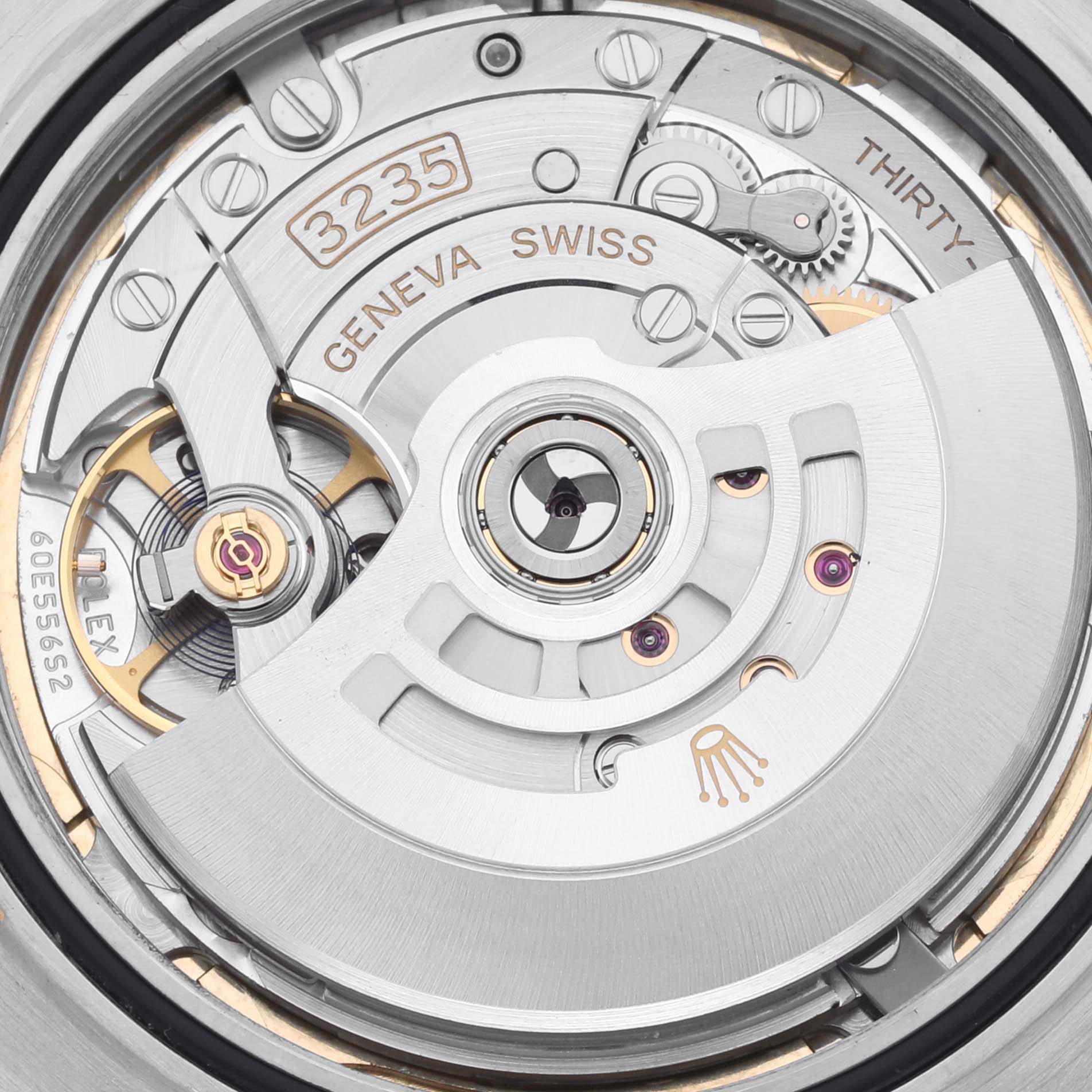 The image shows the movement of a Rolex Datejust 41 126303 Men's Steel and Gold (two tone) Champagne Dial 126303 Men's Steel and Gold (two tone) Champagne Dial, highlighting the intricate details and components from a close-up angle.