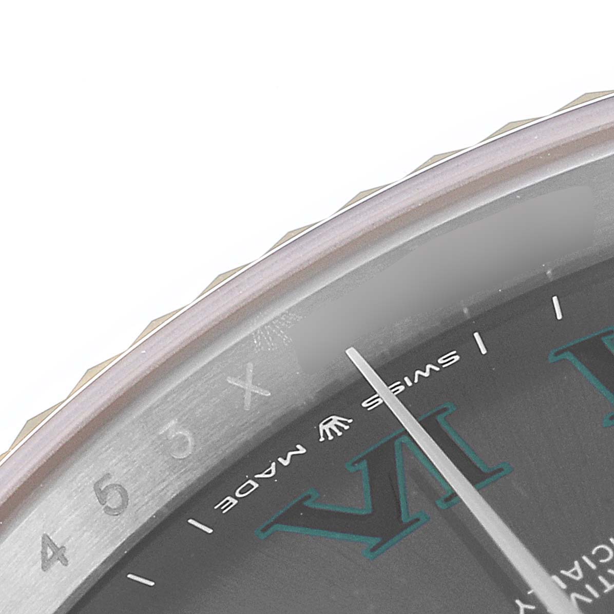 Close-up of the Rolex Datejust 41 126333 Men's Steel and Gold (two tone) Grey Dial 126333 Men's Steel and Gold (two tone) Grey Dial watch's dial, showings parts of the Roman numeral markers and the "Swiss Made" text.