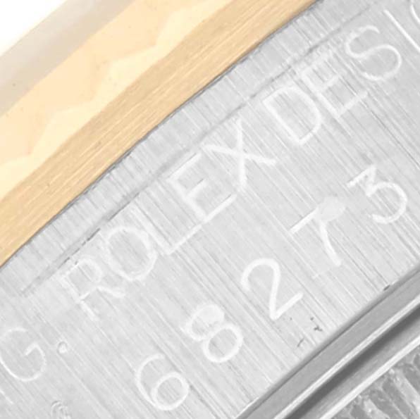 The image shows a close-up of the case with "ROLEX DESIGN" engraving on the Mid-Size Rolex model.