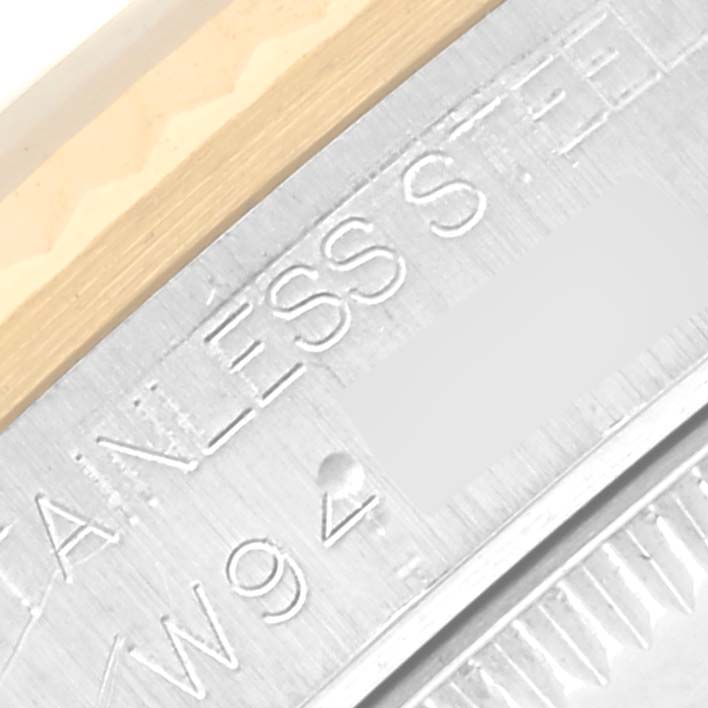 The image shows a close-up of the edge with markings and part of the bezel of a Rolex Mid-Size 68273 Women's Steel and Gold (two tone) White Dial 68273 Women's Steel and Gold (two tone) White Dial watch.