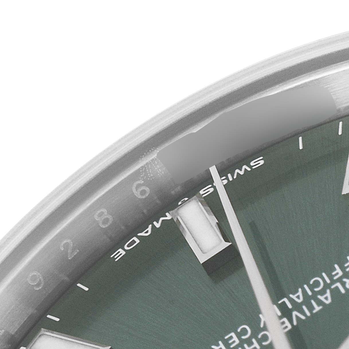 This image shows a close-up of the dial and part of the bezel of a Mid-Size Rolex watch, focusing on the 6 o'clock marker and text detail.