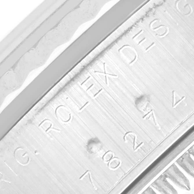 The image shows a close-up of the engraved bezel edge on a Rolex Mid-Size 78274 Women's Stainless Steel Mother of Pearl Dial 78274 Women's Stainless Steel Mother of Pearl Dial watch.