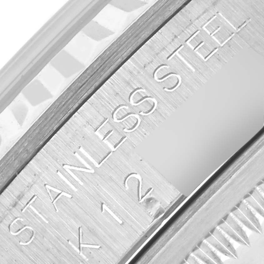 The image shows a close-up of the Rolex Datejust 16234G Men
s Stainless Steel Mother of Pearl Dial 16234G Men
s Stainless Steel Mother of Pearl Dial
s inner bezel with "STAINLESS STEEL" and part of the serial number.