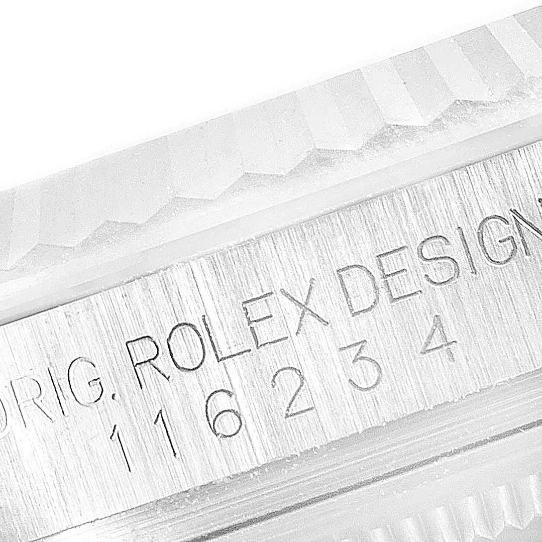 This image shows a close-up view of the engraved model number and design markings on the bezel of a Rolex Datejust 116234 Men's Stainless Steel Silver Dial 116234 Men's Stainless Steel Silver Dial watch.