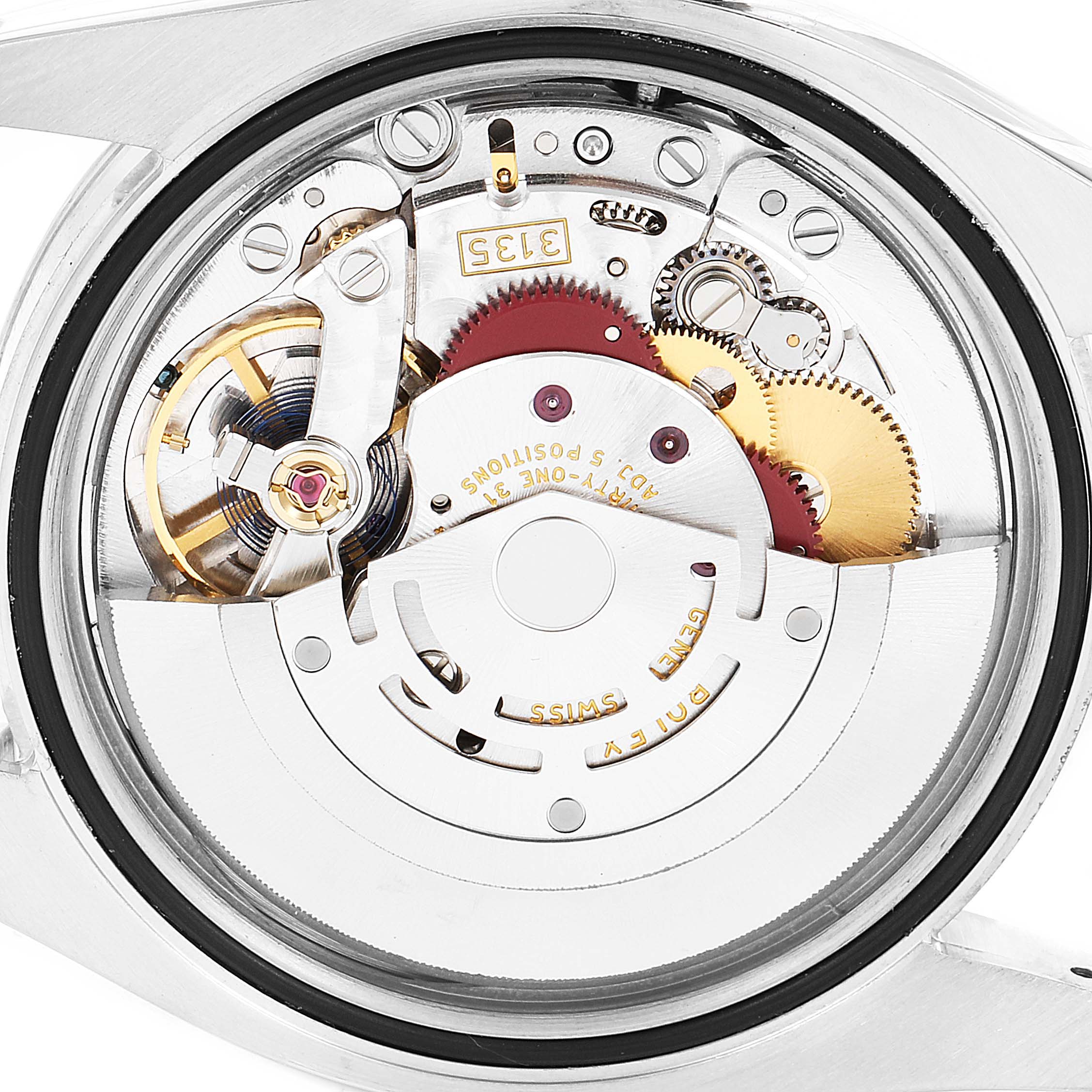 The image shows a close-up view of the movement mechanism inside a Rolex Datejust 116234 Men's Stainless Steel Silver Dial 116234 Men's Stainless Steel Silver Dial watch model, highlighting gears and components.