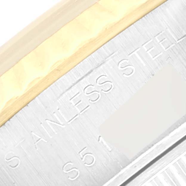 This image shows a close-up of the side of a Rolex Datejust 69173 Women's Steel and Gold (two tone) Black Dial 69173 Women's Steel and Gold (two tone) Black Dial watch, focusing on the edge of the case with "STAINLESS STEEL" engraved.