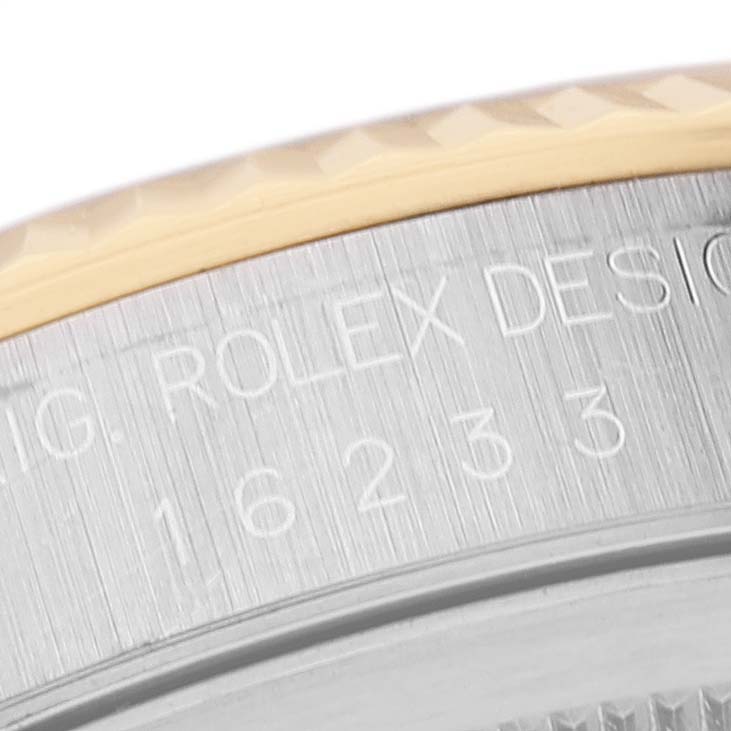 This close-up image shows the side of the Rolex Datejust 16233 Men's Steel and Gold (two tone) Black Dial 16233 Men's Steel and Gold (two tone) Black Dial model, highlighting the engraving and part of the bezel.