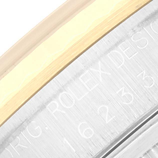 This close-up angle of the Rolex Datejust 16233 Men's Steel and Gold (two tone) Champagne Dial 16233 Men's Steel and Gold (two tone) Champagne Dial watch shows the bezel and part of the engraved case side.