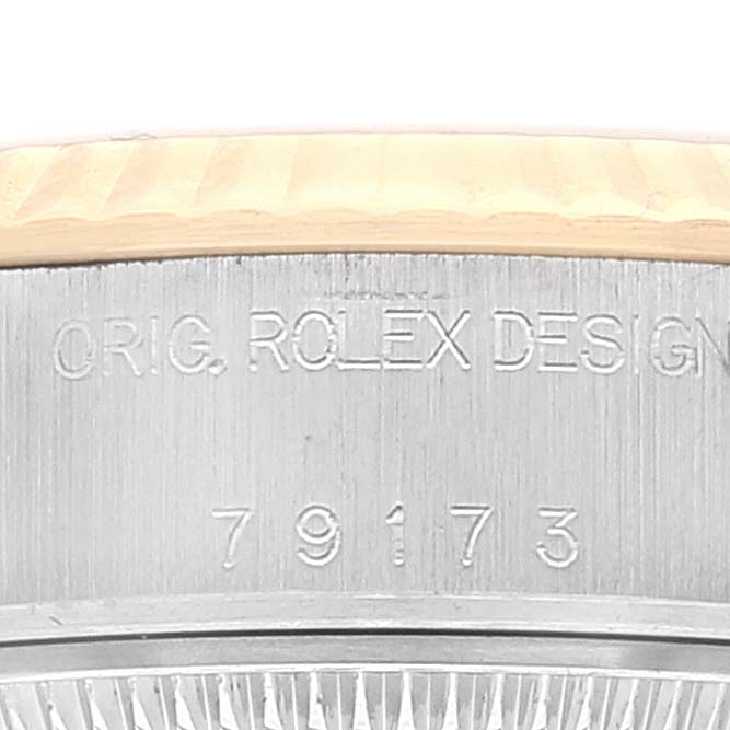 The image shows the engraving on the side of the case of a Rolex Datejust 79173 Women's Steel and Gold (two tone) Champagne Dial 79173 Women's Steel and Gold (two tone) Champagne Dial watch.