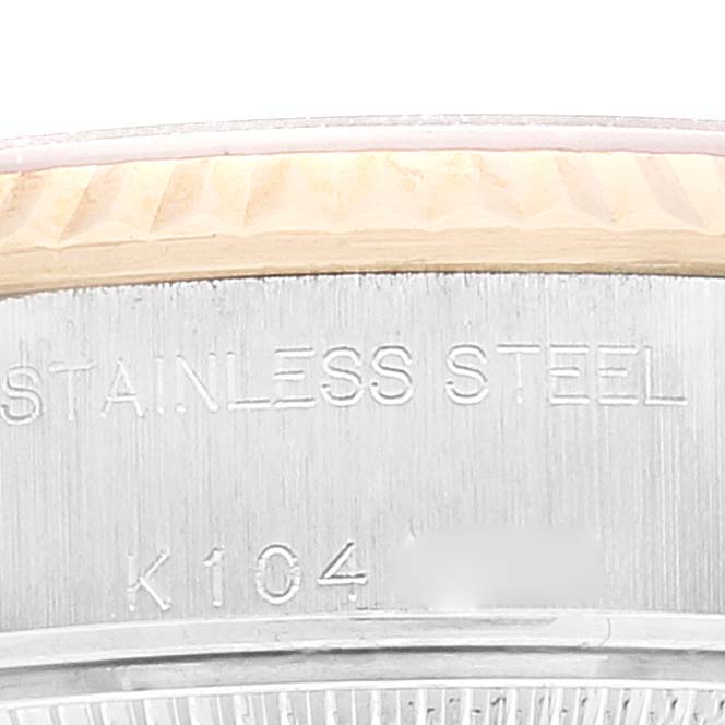 The image shows a close-up of the side of a stainless steel Rolex Datejust 79173 Women's Steel and Gold (two tone) Champagne Dial 79173 Women's Steel and Gold (two tone) Champagne Dial watch case with the model and material engraved.