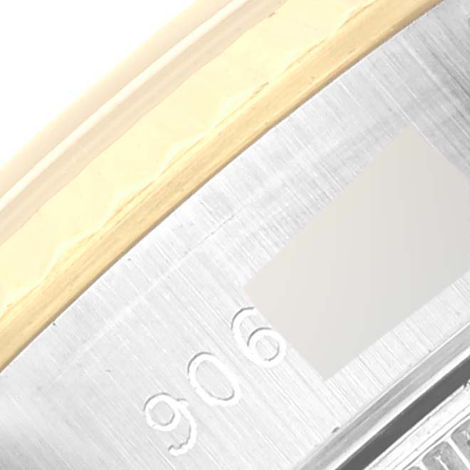 Close-up of the Rolex Datejust 69173 Women's Steel and Gold (two tone) Champagne Dial 69173 Women's Steel and Gold (two tone) Champagne Dial model's case, highlighting the metallic edge and part of the engraved serial number.