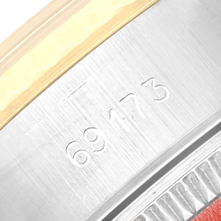 This image shows the serial number and part of the bezel of a Rolex Datejust 69173 Women's Steel and Gold (two tone) Champagne Dial 69173 Women's Steel and Gold (two tone) Champagne Dial watch.