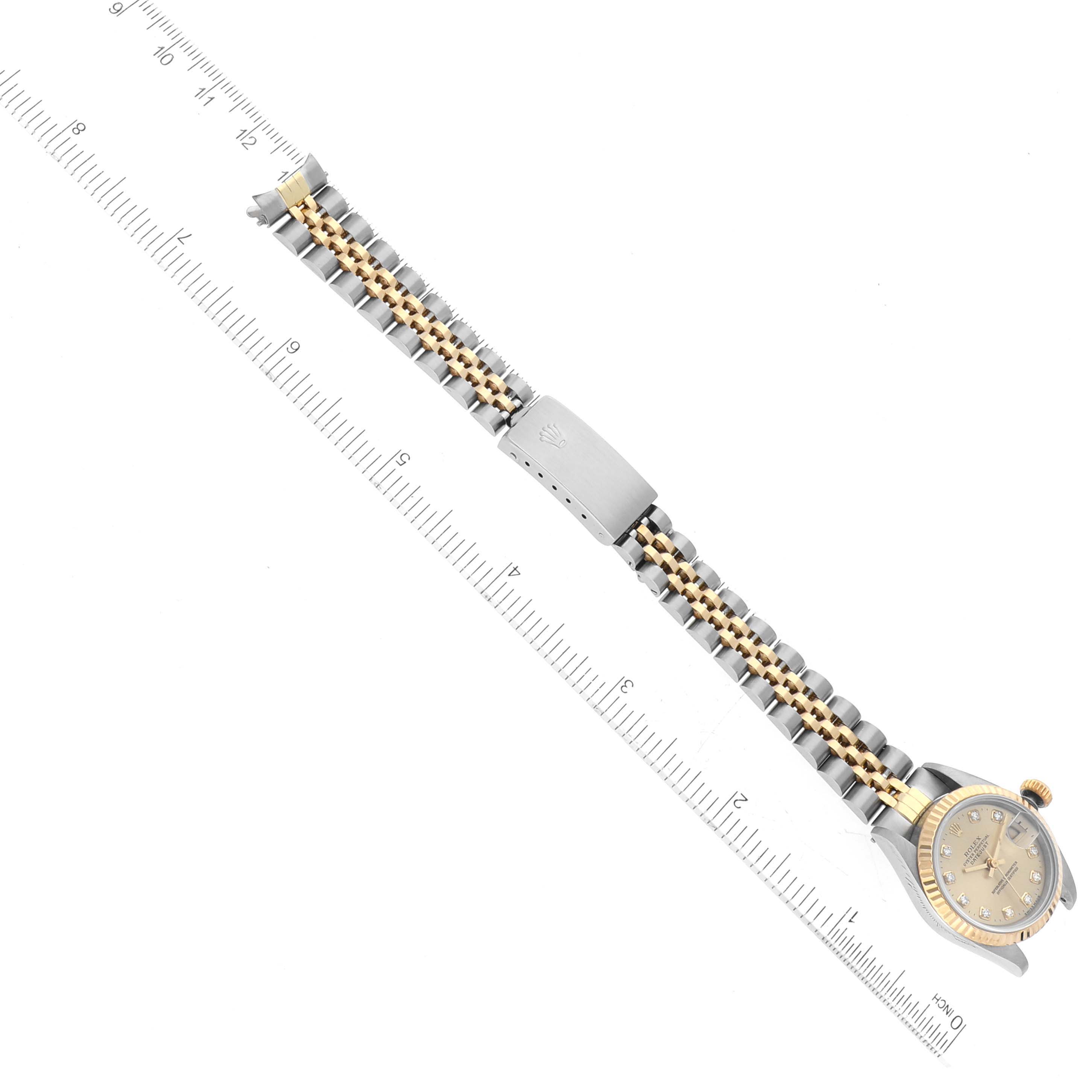 The image shows a Rolex Datejust 69173 Women's Steel and Gold (two tone) Champagne Dial 69173 Women's Steel and Gold (two tone) Champagne Dial watch laid flat with the dial, crown, and full bracelet visible alongside a measuring ruler.