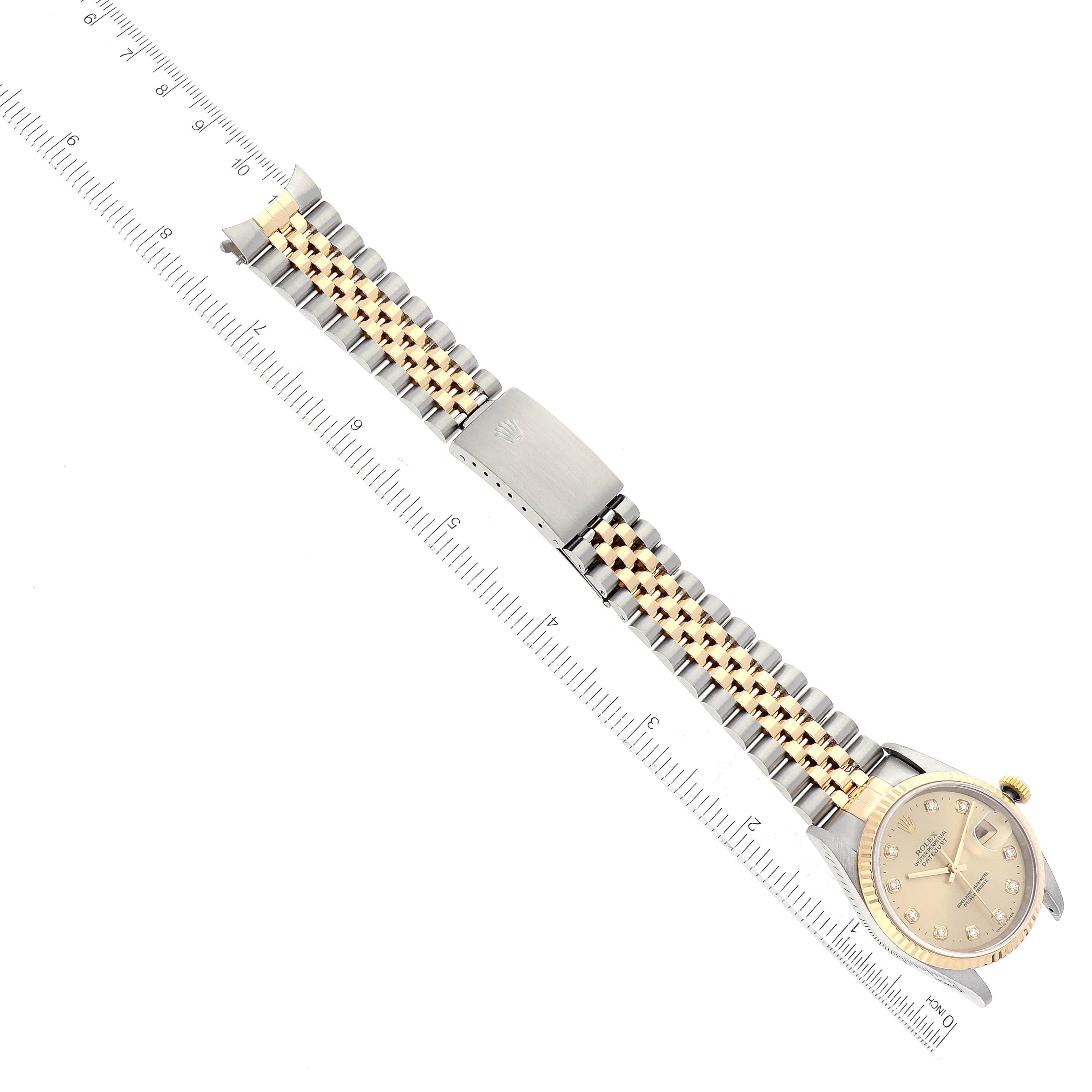 The image shows a top-down view of a Rolex Datejust 16233 Men's Steel and Gold (two tone) Champagne Dial 16233 Men's Steel and Gold (two tone) Champagne Dial watch with a two-tone bracelet and a closed clasp.
