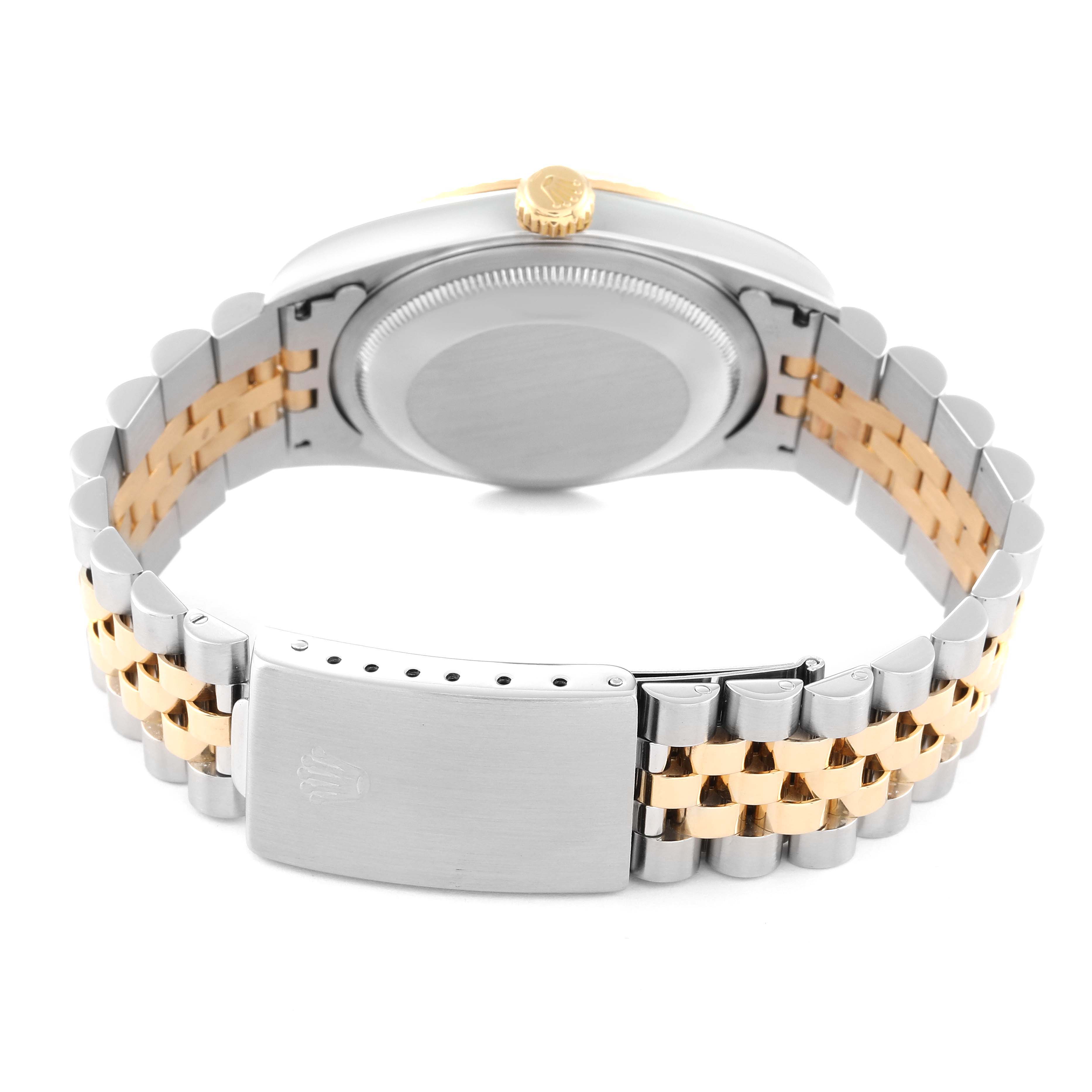 The image shows the back of a Rolex Datejust 16233 Men's Steel and Gold (two tone) Champagne Dial 16233 Men's Steel and Gold (two tone) Champagne Dial watch, featuring its case, crown, and two-tone metal bracelet with a clasp.