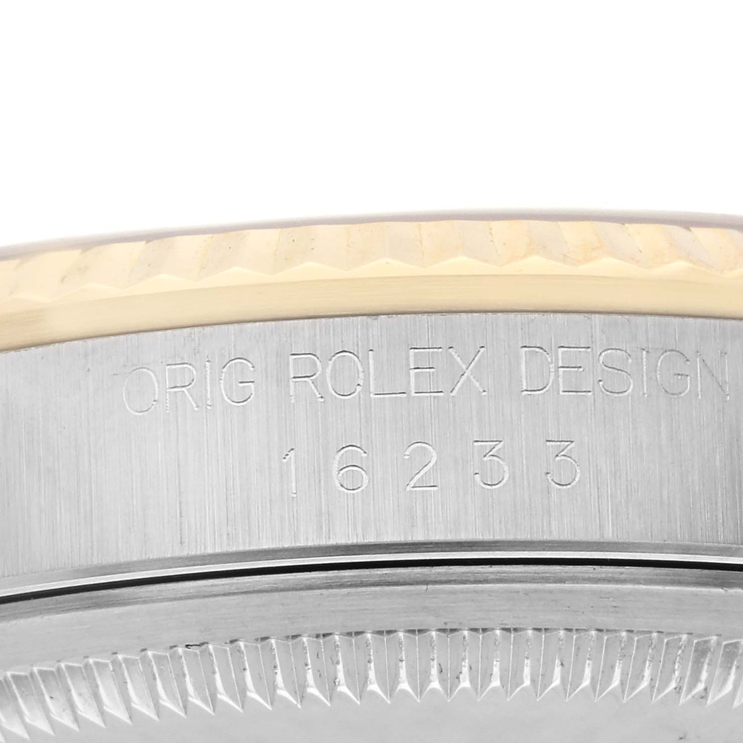 The image shows the side of a Rolex Datejust 16233 Men's Steel and Gold (two tone) Champagne Dial 16233 Men's Steel and Gold (two tone) Champagne Dial case, highlighting the model number and fluted bezel.