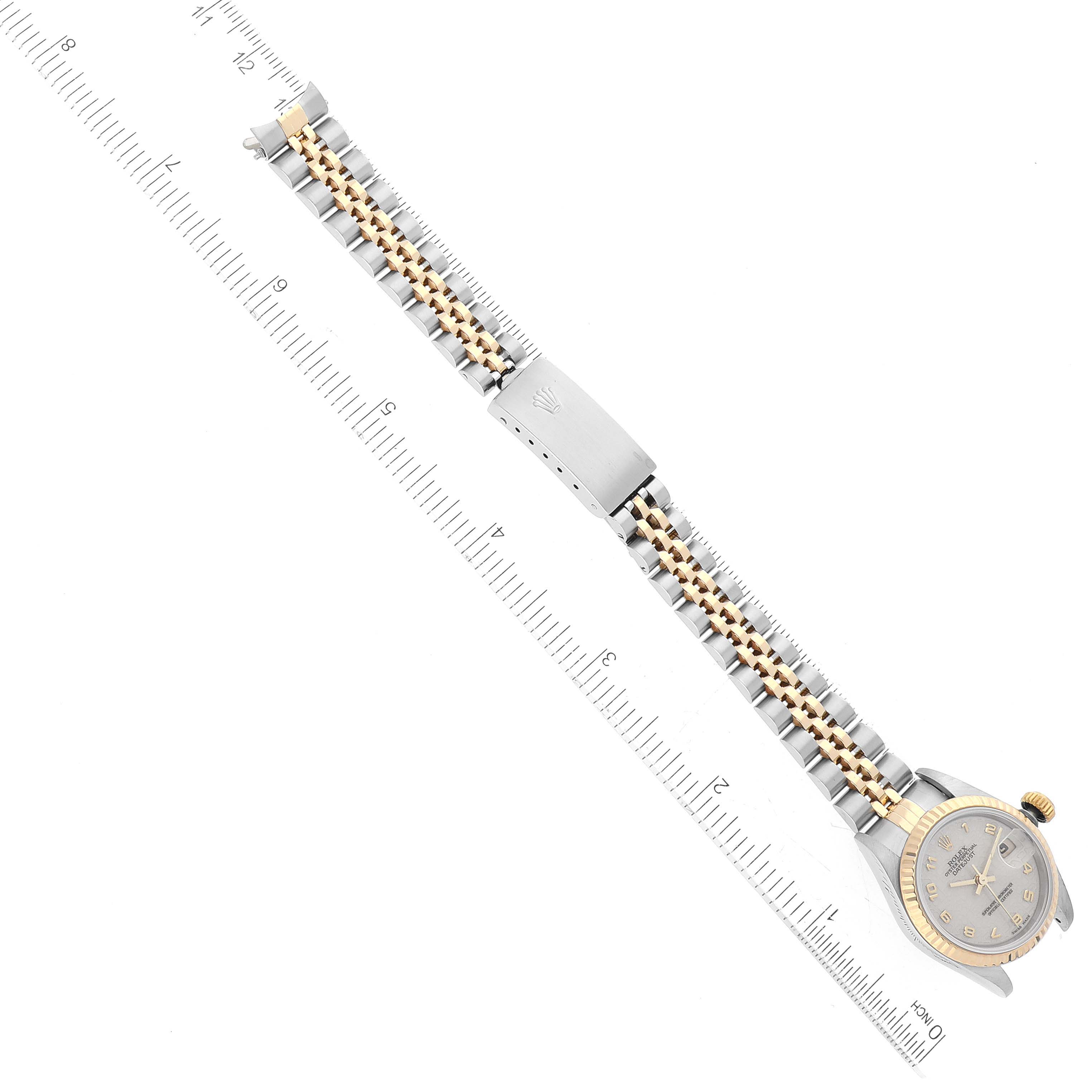 The image shows the Rolex Datejust 69173 Women's Steel and Gold (two tone) White Dial 69173 Women's Steel and Gold (two tone) White Dial watch laid flat with a ruler alongside for measurement reference.