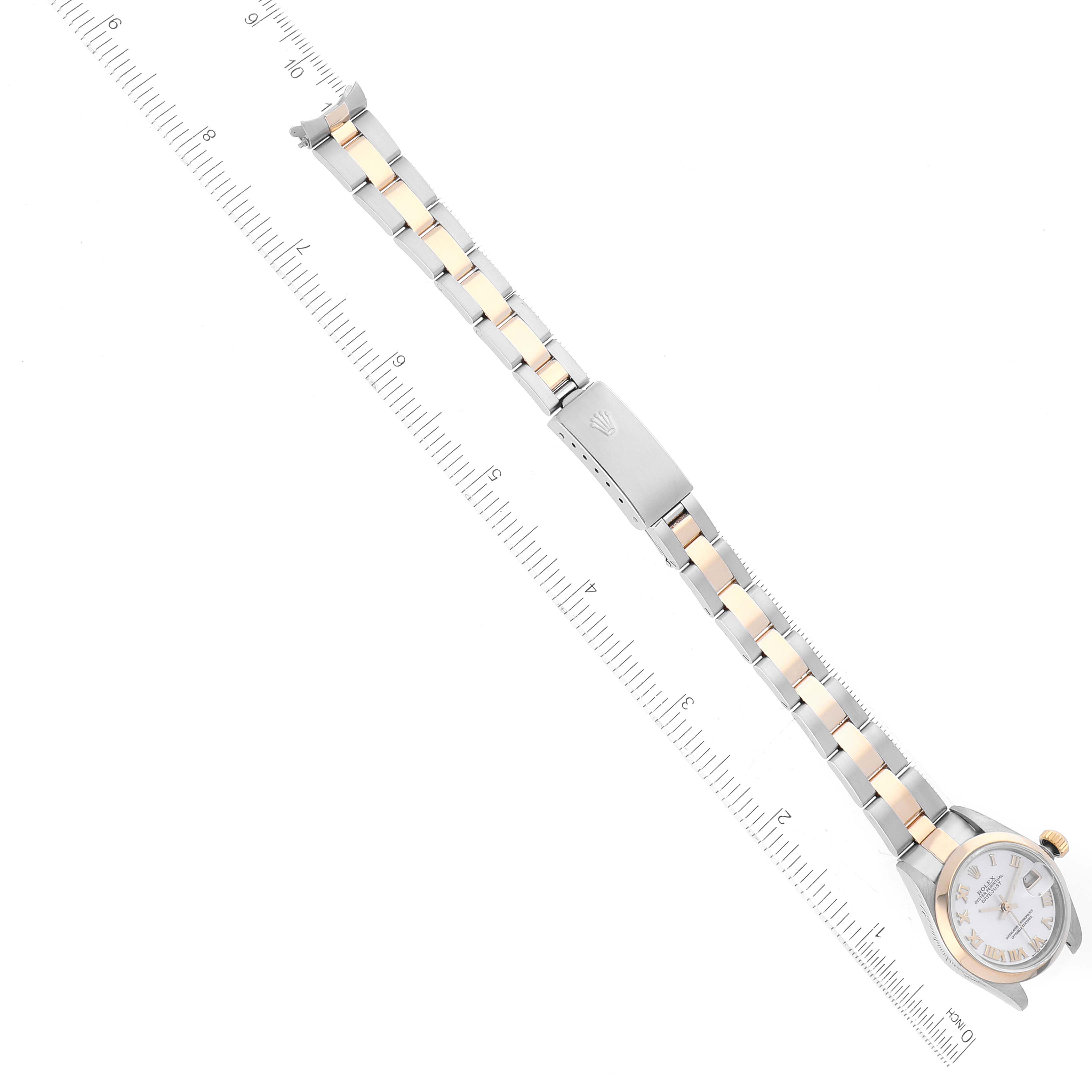 The image shows a top-down view of a Rolex Datejust 79163 Women's Steel and Gold (two tone) Mother of Pearl Dial 79163 Women's Steel and Gold (two tone) Mother of Pearl Dial watch, featuring the face, bracelet, and clasp, placed alongside a ruler for scale.