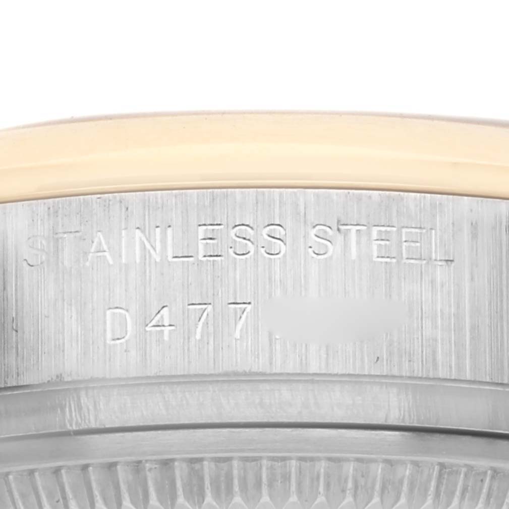 The image shows the side of a Rolex Datejust 179163 Women's Steel and Gold (two tone) White Dial 179163 Women's Steel and Gold (two tone) White Dial watch, highlighting the stainless steel edge with engraved details.