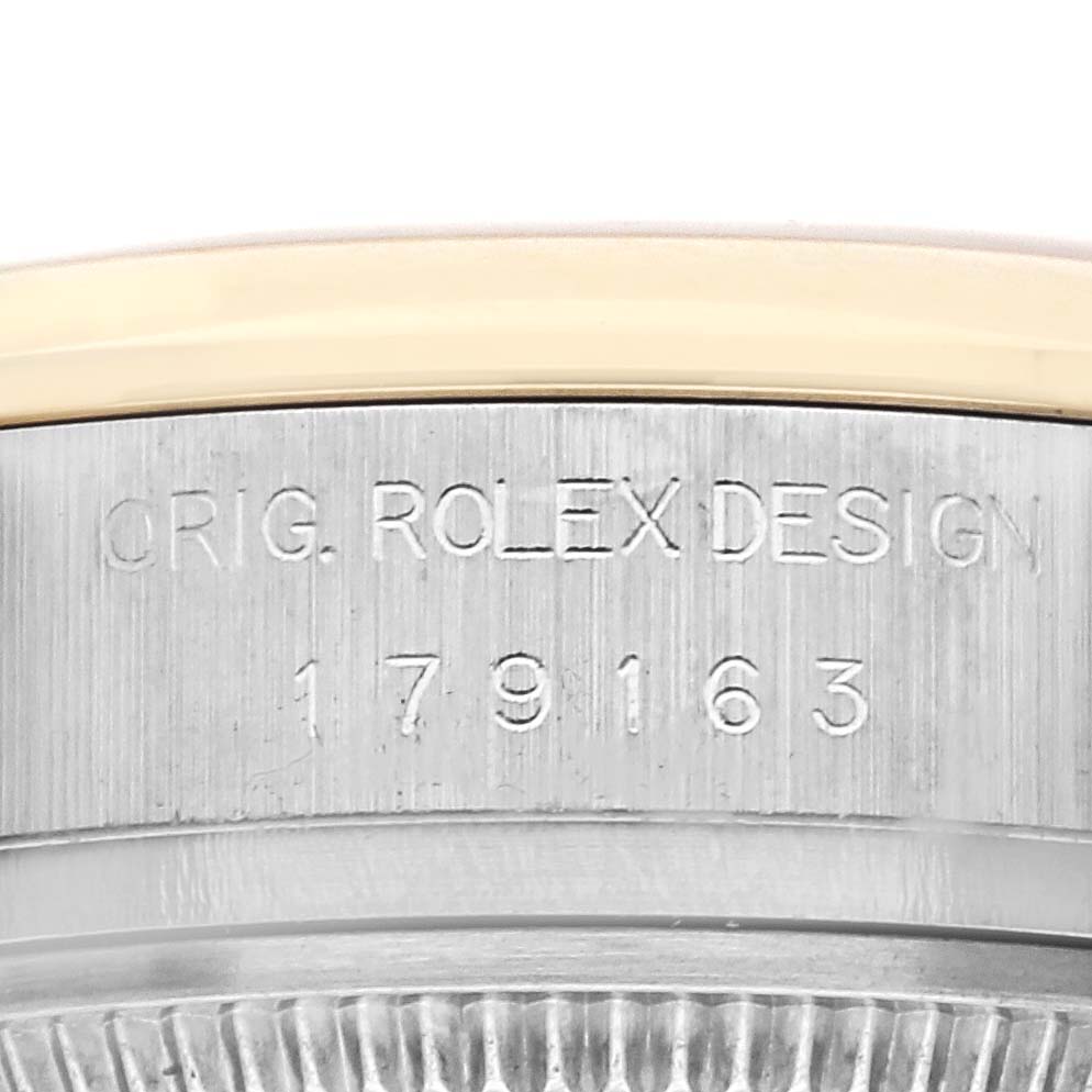 This image shows the side view of a Rolex Datejust 179163 Women's Steel and Gold (two tone) White Dial 179163 Women's Steel and Gold (two tone) White Dial watch, focusing on its engraved serial number and branding.