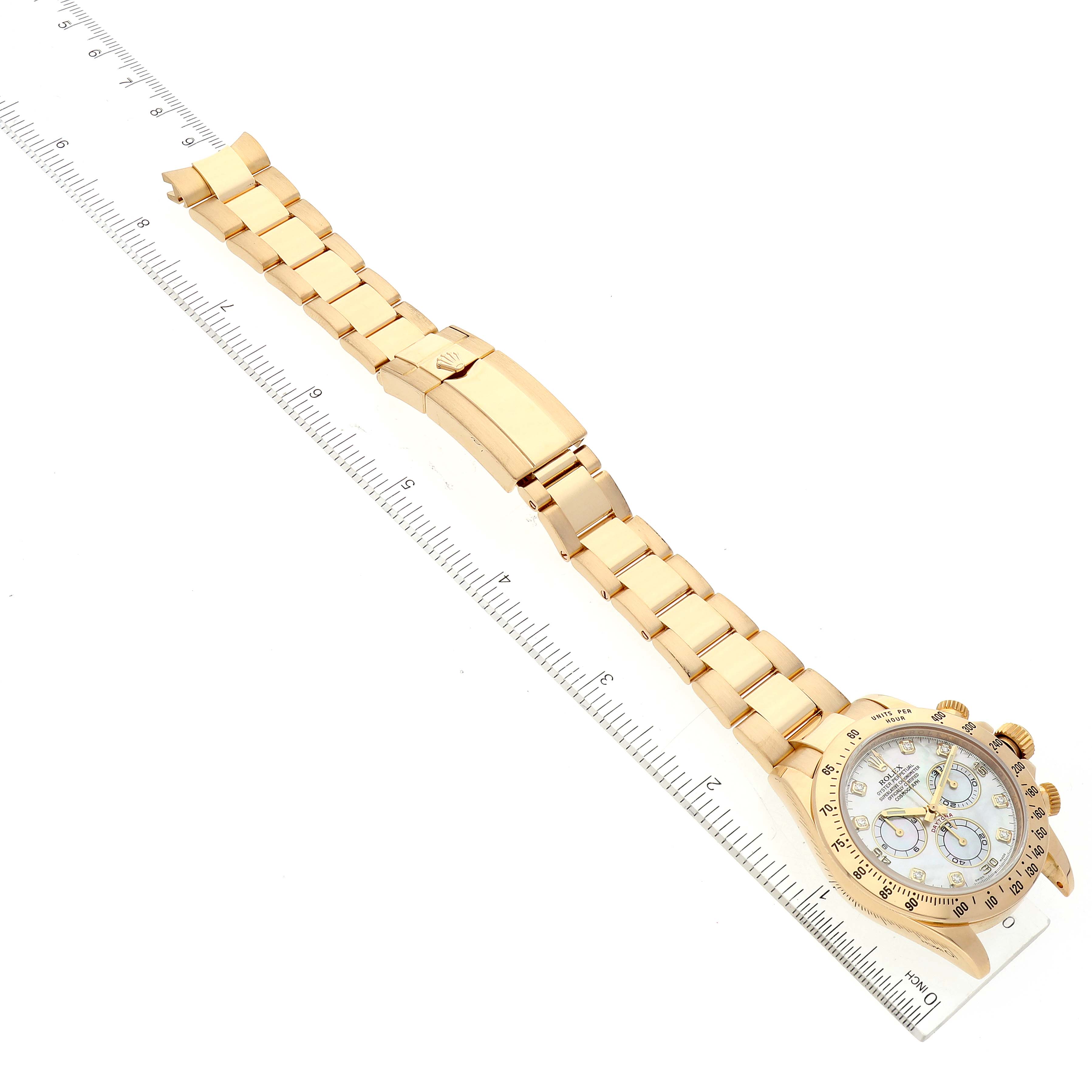 The image shows a Rolex Daytona 116528 Men's Yellow Gold Mother of Pearl Dial 116528 Men's Yellow Gold Mother of Pearl Dial watch laid flat, with the full bracelet and dial visible, measured against a ruler.