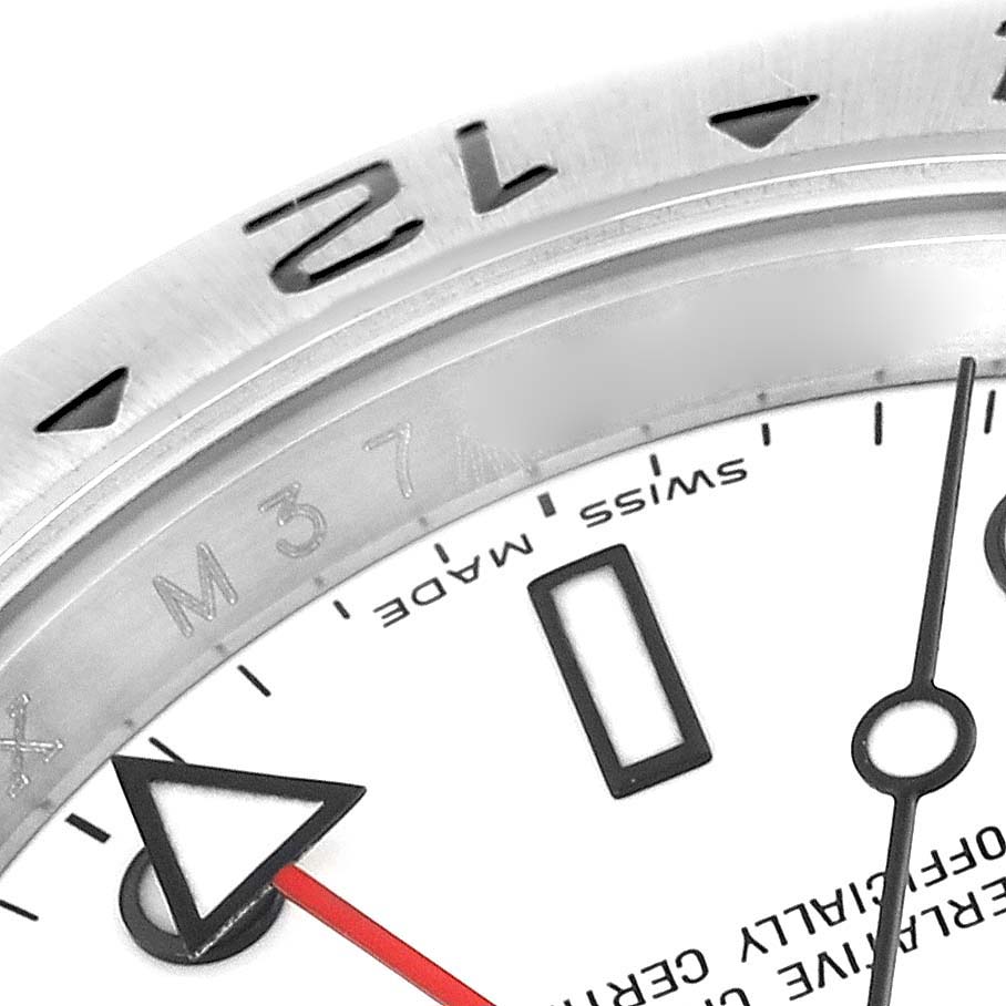 The image shows a close-up of the dial and bezel at an angle, highlighting the 12-hour marker of a Rolex Explorer 16570 Men's Stainless Steel White Dial 16570 Men's Stainless Steel White Dial watch.